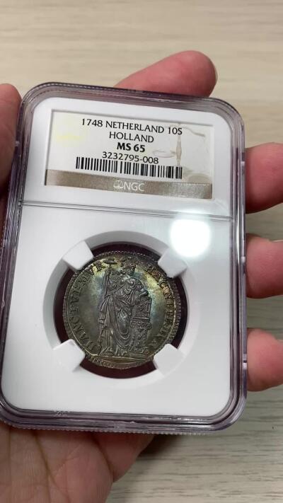 万国钱币拍卖第060期（万国六十期纪念大拍） NGC MS65 1748荷兰站人10S银币 全深打欧陆七彩裹身 NGC老盒顶级收藏品质
