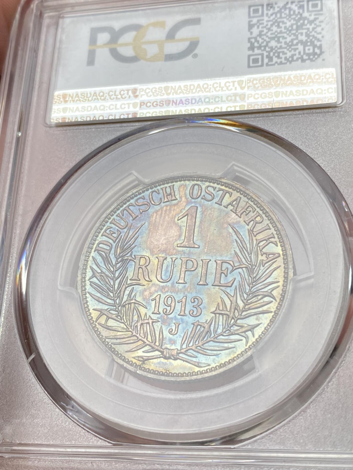 万国钱币拍卖第060期（万国六十期纪念大拍） PCGS MS64 1913德属东非威廉二世戎装1卢比银币 德属热门品种 高分极其难得 丝绸转光底板绚烂孔雀蓝彩环绕  PC唯二冠军