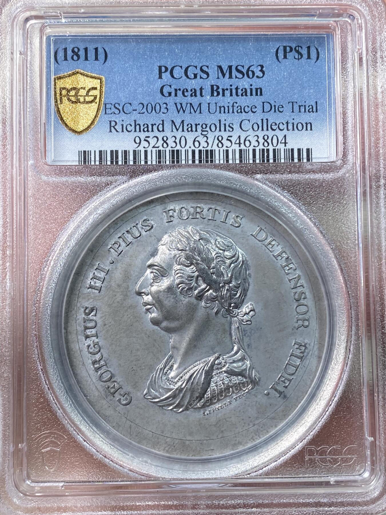 万国钱币拍卖第060期（万国六十期纪念大拍）  PCGS MS63 1811年英格兰银行系列乔治三世1元样币-正面铸样 经过改动后此头像被用于5先令又6便士的样币上。理查德·马乔里旧藏，法国与英国SOHO MINT铸币的专家，1958年成为币商，后期设计铸造了大名鼎鼎的古巴流亡政府少女比索银币，最后被美国政府查抄模具而收场。他上世纪60年代以来购买的出自包括法鲁克国王、苏尔曼等顶级集藏的英法藏品近两年来屡屡排出高价。附带原标签和纸袋。