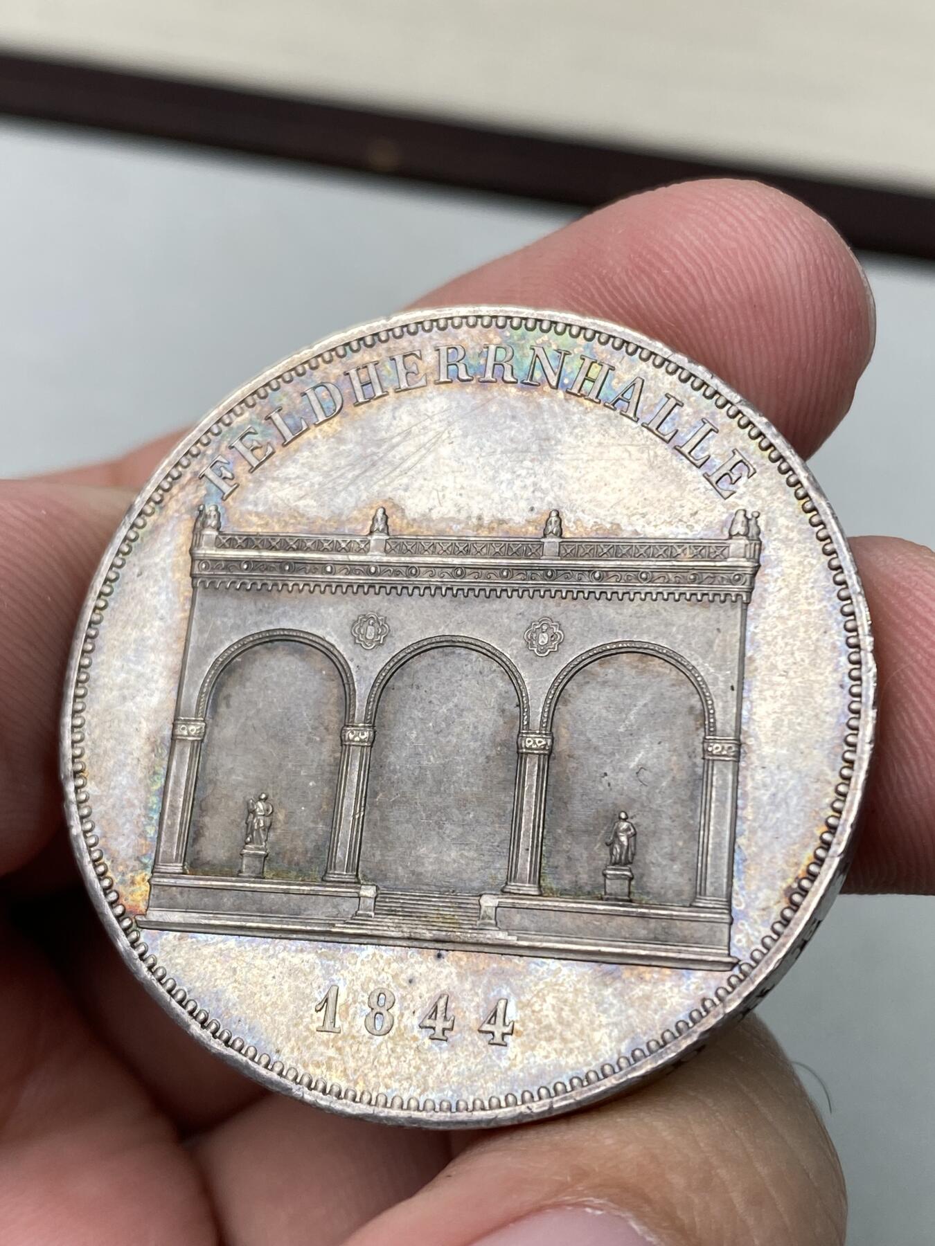 万国钱币拍卖第060期（万国六十期纪念大拍） 1844年德国巴伐利亚路德维希一世统帅堂历史2泰勒 为庆祝统帅堂在慕尼黑落成而发行了此枚历史2泰勒加以纪念，统帅堂的造型模仿了弗洛伦萨佣兵长廊的造型，为了纪念巴伐利亚的统帅和怀念君主时代的辉煌胜利而建，现已成为了慕尼黑的标志性建筑之一。原味五彩转光难得好品收藏级