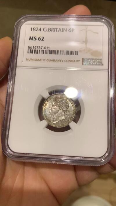 《竞宝斋》第464场 周日，周一，周二，3场连拍 （全场包邮）欢迎送拍 NGC MS62 英国1824年乔治四世国王6便士银币，铸造于英国皇家造币厂，正面有明显的镜面感以及蓝调包浆，非常漂亮，背面灰色包浆，细节完整。整体非常舒服。