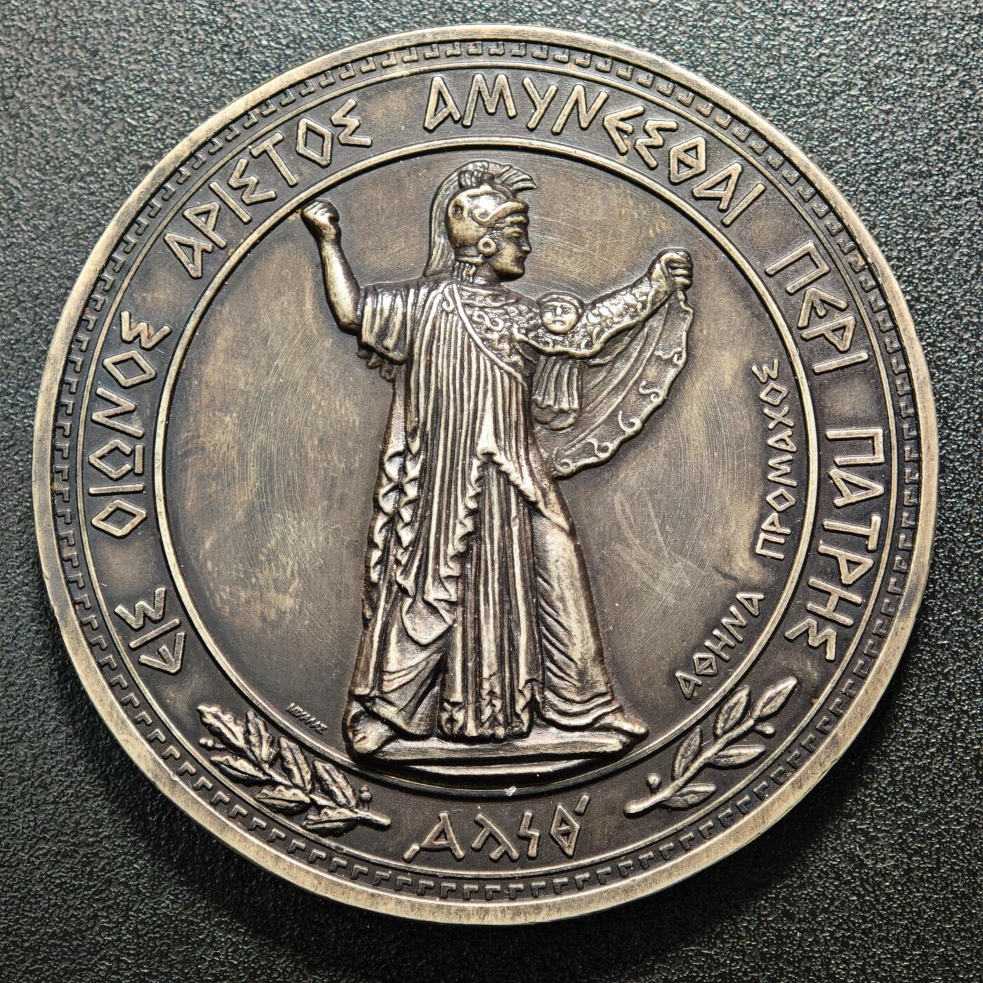 【德藏】世界币章拍卖第164期（拍品征集中~欢迎藏友联系） 20世纪初希腊国防部纪念大银章  直径约：70.3mm；重约：156.1g 欧洲黑包浆，雕刻精美，原装盒子，收藏价值高。正面是头戴战盔、身披长袍的古希腊神话中智慧、战争与守护女神雅典娜的站立像；背面中间是装饰有希腊国徽、海锚、头盔、交叉的箭头等元素的盾牌，盾牌上方文字是希腊语“ΑΜΥΝΕΣΘΑΙ ΠΕΡΙ ΠΑΤΡΗΣ（为祖国而战）”