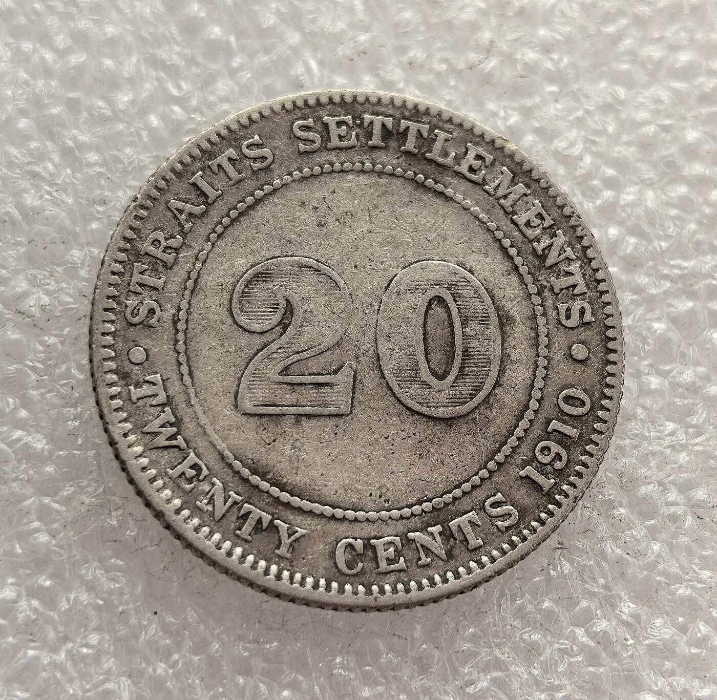 外国优质老铜币高银银币，周六九点倒数截拍，满百包邮，持续收拍，年后发货 英属海峡殖民地 1910 年   20 分银币，属于爱德华七世时期的流通货币。当时海峡殖民地是英国在东南亚的商贸核心，该币以国王头像与面值为设计，见证了英国殖民统治下东南亚的货币统一与商贸繁荣。