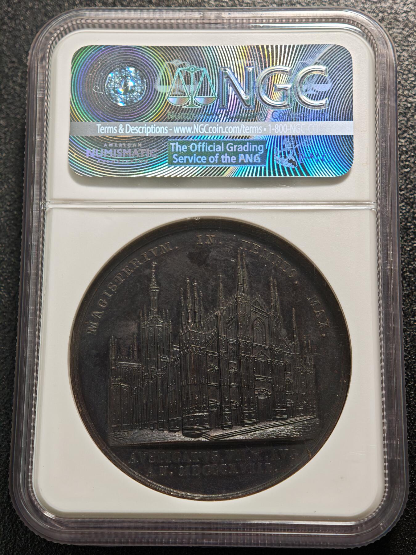 【德藏】世界币章拍卖第165期（拍品征集中~欢迎藏友联系） 1818年 意大利米兰大主教在米兰大教堂就职典礼44mm高浮雕纪念铜章 NGC MS61 正面是大主教胸前佩戴十字架右侧面肖像，背面是米兰大教堂建筑立面。高浮雕工艺，经历200多年历史沧桑仍品相完好，少见品种，可遇不可求