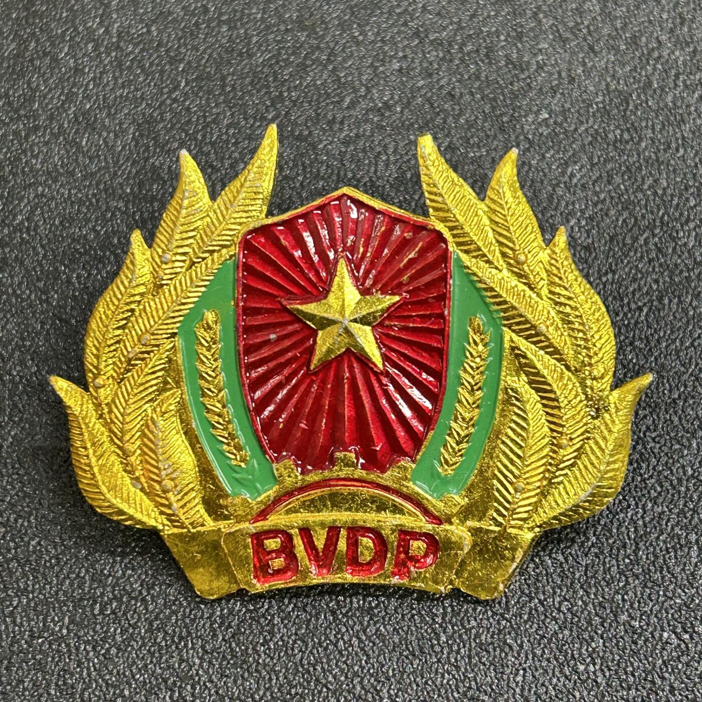 西秦中古拍卖第七十七期 2026马年新春专场 本场拍品年初九发出 越南基层安全维护部队帽徽 不脱产的群众武装力量，由政府和人民委员会管理控制，接受各级军事机关指导和直接指挥。其成员来自符合条件的公民，男满18至45岁、女满18至40岁且身体健康者都有义务参加。主要任务包括随时准备战斗，配合公安、边防部队等捍卫领土主权、政治安宁和社会安全秩序等