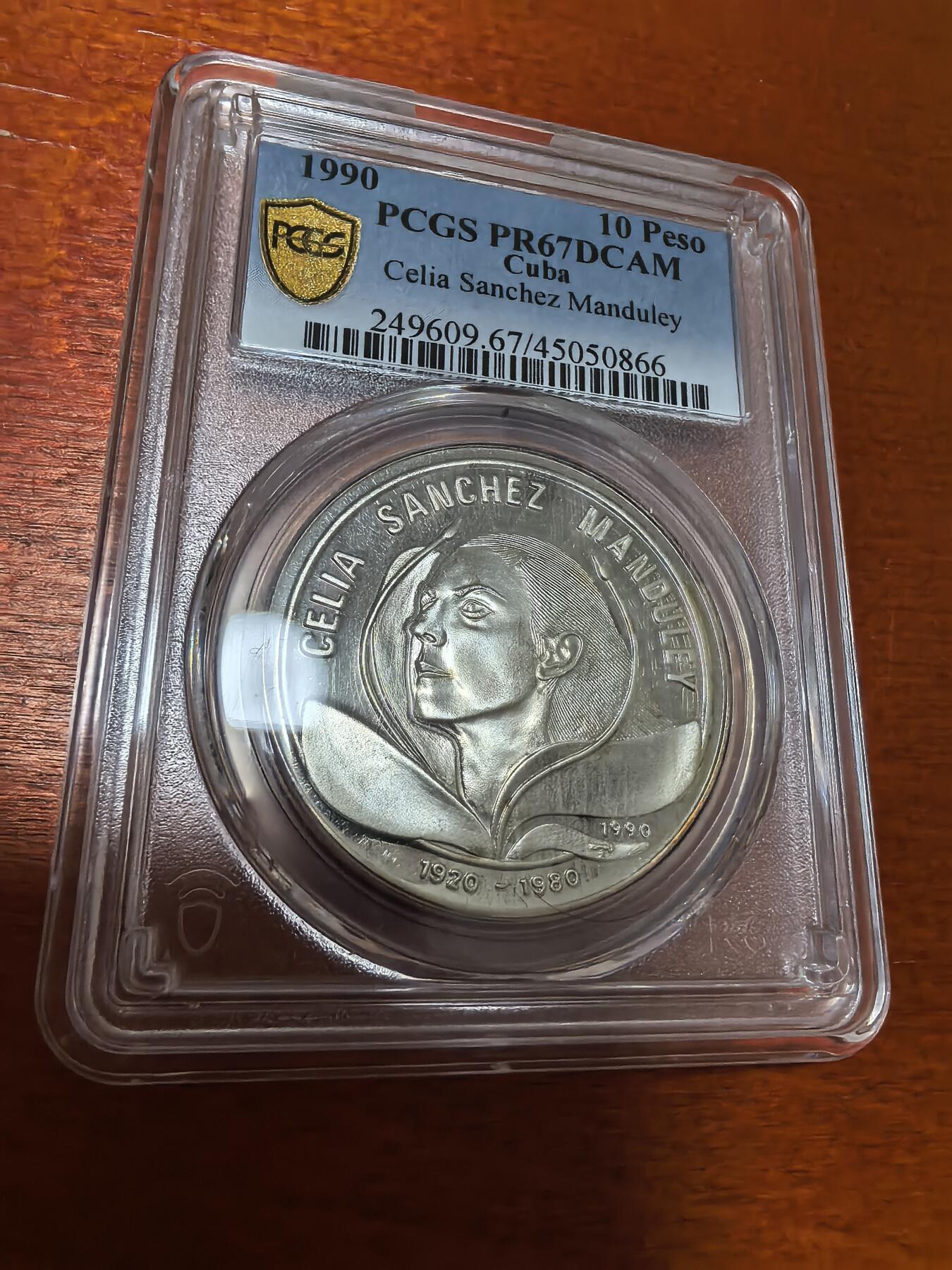 长老汇蛇年精选第一百场拍卖 1990 古巴革命者西莉娅·桑切斯·曼杜利10比索精制银币，PCGS PR67DCAM，唯一冠军，2000枚