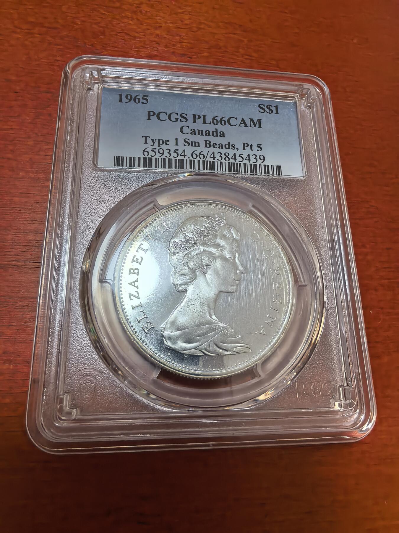 长老汇蛇年精选第一百场拍卖 1965加拿大伊丽莎白二世1加元类精制银币，PCGS PL66CAM，超高分，版别小珠点，尖5，65分克书标价750美金