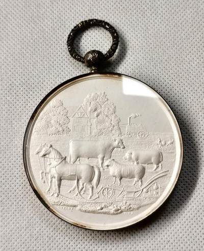 “福币呈祥”新年甄品场（直播拍卖）甄臻铺-世界币章拍卖（第50期），送拍享返佣金等优惠多多 - 1858年英国Worcestershire农业协会银质奖章，直径65毫米，重122克，反面玻璃罩丢失，全网农业玻璃罩章牌最大尺寸，雕工也是最精致传神的，好一幅勃勃生机的农业画卷啊。正面高浮雕农庄、牛、马、猪、羊等农畜，背面麦穗花环环绕协会名称和年份。由OTTLEY大师雕刻