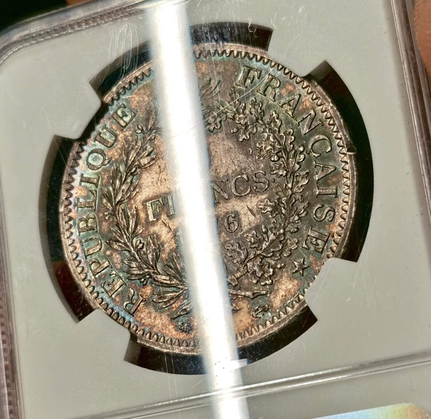 “福币呈祥”新年甄品场（直播拍卖）甄臻铺-世界币章拍卖（第50期），送拍享返佣金等优惠多多 NGC-UNC 1876年法国5法郎大银币 正面转光 背面包浆厚彩 适当养护可搏分