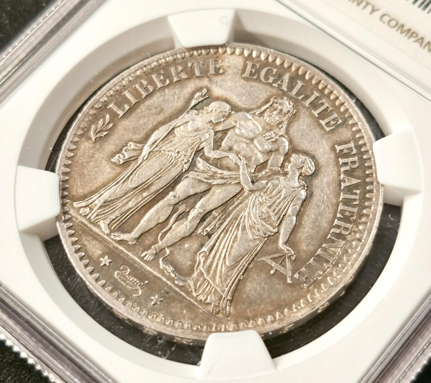 “福币呈祥”新年甄品场（直播拍卖）甄臻铺-世界币章拍卖（第50期），送拍享返佣金等优惠多多 NGC-UNC 1876年法国5法郎大银币 正面转光 背面包浆厚彩 适当养护可搏分