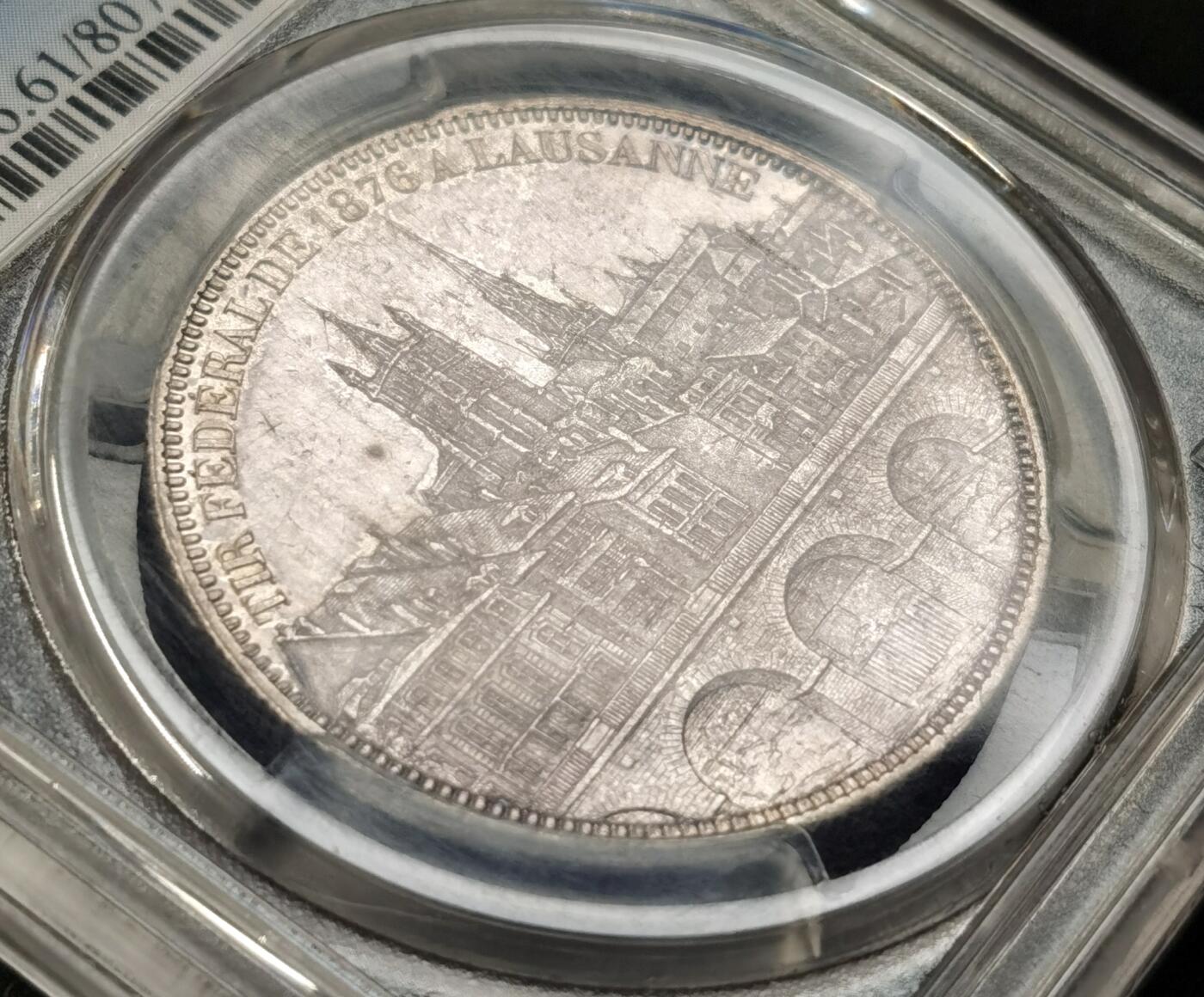 “福币呈祥”新年甄品场（直播拍卖）甄臻铺-世界币章拍卖（第50期），送拍享返佣金等优惠多多 PCGS-MS61 1876年瑞士洛桑射击节5法郎银币，紫罗兰包浆，背后的洛桑城景观细节一流，发行量20000枚，喜欢瑞射景观的不能错过的一枚。