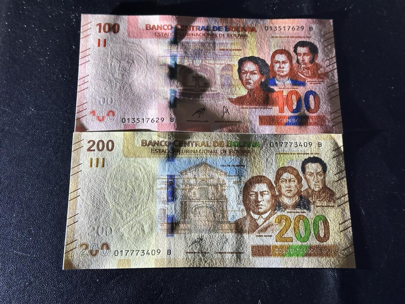 《外钞收藏家》第六百一十一期（农历新年第一场/快递恢复正常再发货）（长期征集拍品、欢迎藏友们联系合作） 玻利维亚100和200面额 2张一起 全新 尾（29、09）一个角不绝