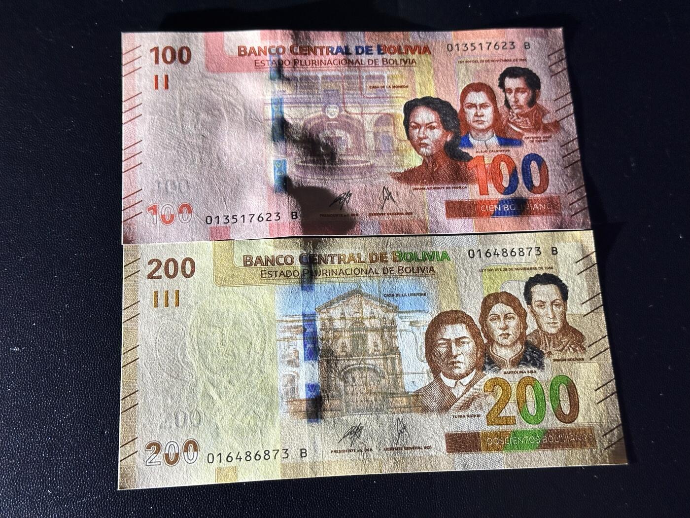 《外钞收藏家》第六百一十一期（农历新年第一场/快递恢复正常再发货）（长期征集拍品、欢迎藏友们联系合作） 玻利维亚100和200面额 2张一起 全新 尾（23、73）