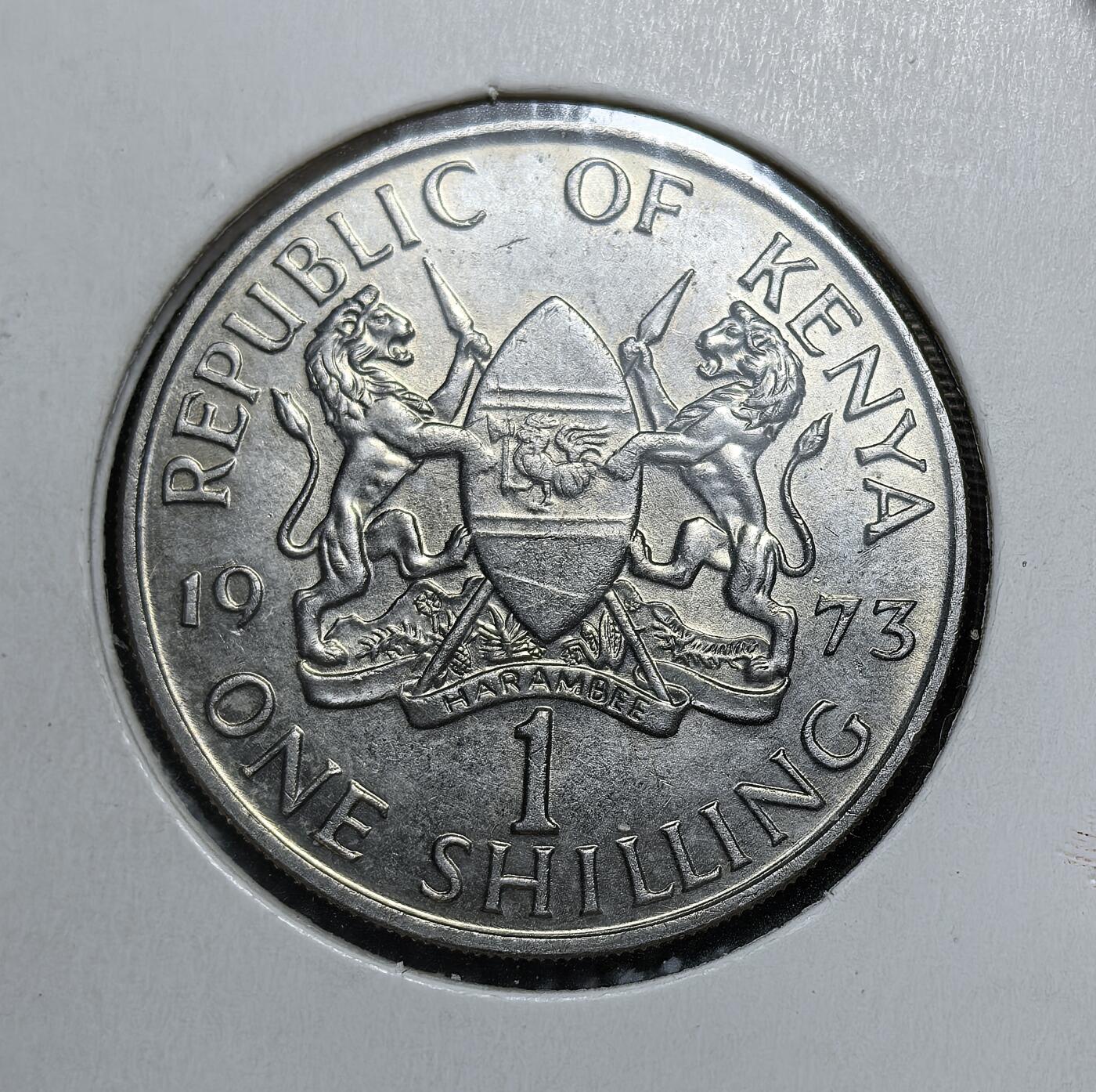 外国优质老铜币银币，正月十二晚九点倒数截拍，满百包邮可寄存，持续收拍 肯尼亚1973 年1 先令币，正面为开国总统乔莫・肯雅塔头像，背面是肯尼亚国徽与 “Harambee（齐心协力）” 格言。此币属于 1969 版系列，见证了肯尼亚独立后自主货币体系的巩固与国家建设历程。