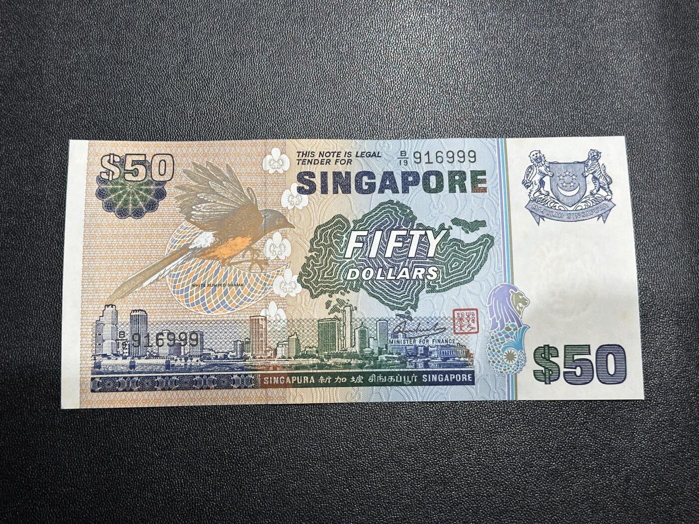 《外钞收藏家》第六百一十三期（ 精品场）（长期征集拍品、欢迎藏友们联系合作） 新加坡鸟版50元（音乐题材纸币，全程无47豹子号999）	UNC 但有潮斑