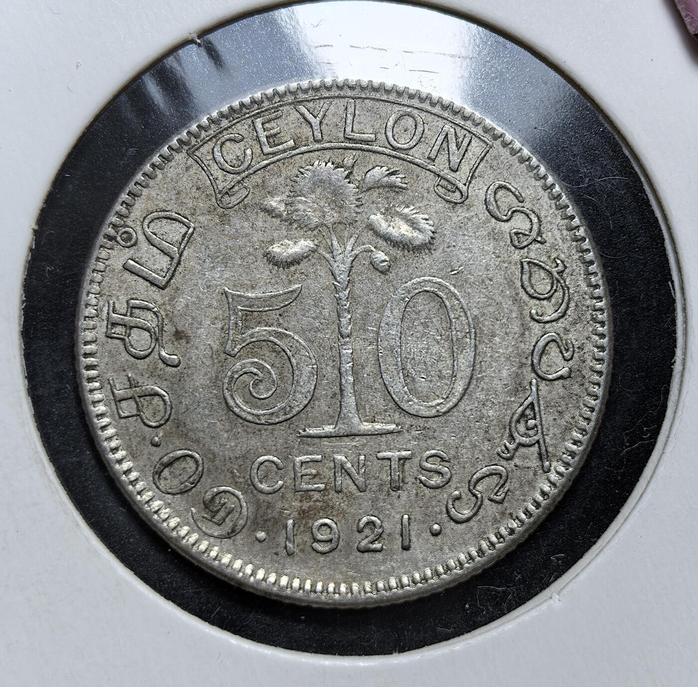 外国优质老铜币银币，正月十二晚九点倒数截拍，满百包邮可寄存，持续收拍 英属锡兰1921年50分银币，正面为英王乔治五世像，背面是锡兰国树铁木树与双语面值。发行于一战后经济恢复期，是英国殖民统治的货币遗存，见证了锡兰的殖民贸易与多元文化融合。