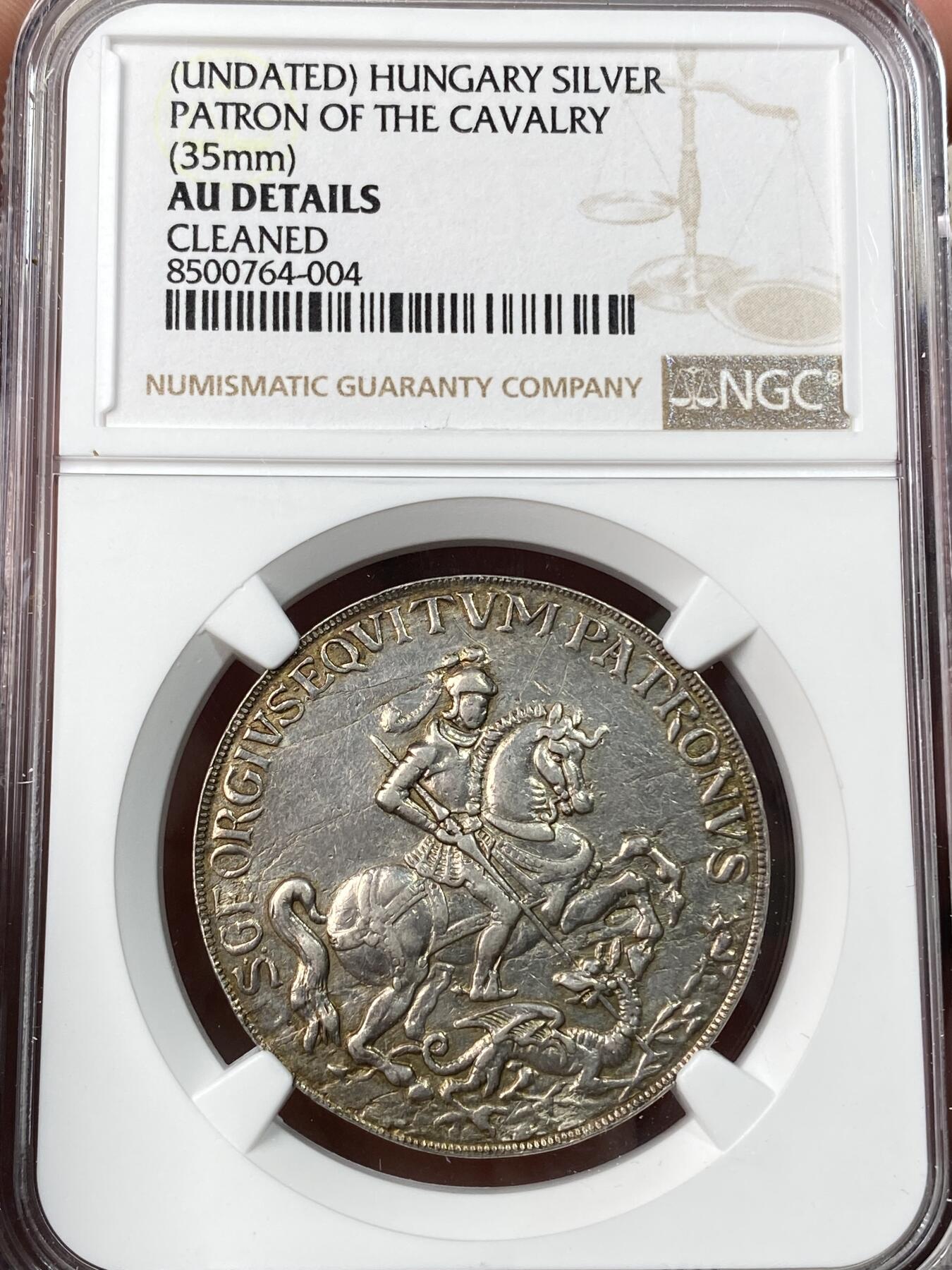 万国钱币拍卖第062期 NGC AUD 18~19世纪匈牙利圣乔治屠龙银章 是当时旅行者和航海工作者的护身符 此枚保存相当完好香槟淡彩环绕极其美丽