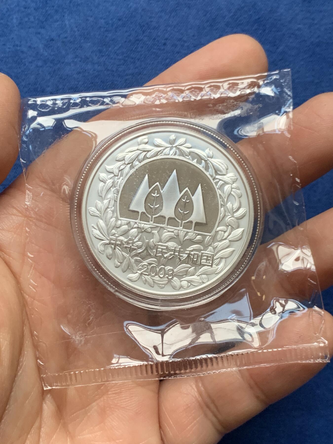 《竞宝斋》第466场 周日，周一 2场连拍 （全场包邮）欢迎送拍 中国2003年林海飞鸟银币 环保植树主题 发行量3万 999银 1盎司 31.1克。原封装好品，无氧化无白斑。