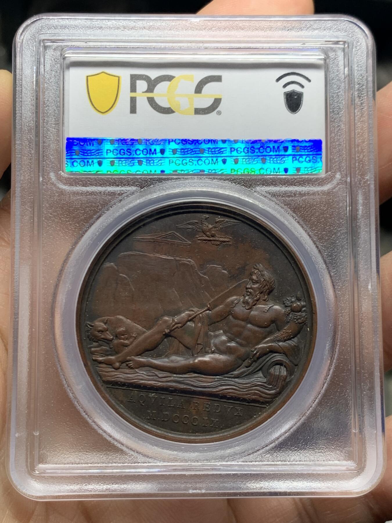 《竞宝斋》第468场 周日，周一 2场连拍 （全场包邮）欢迎送拍 亚军分 PCGS SP64 亚军分  法国1809 拿破仑一世法兰西帝国兼并罗马原铸铜章 巴黎造币厂 巧克力包浆 台伯河之神倚靠着双耳壶流淌出河水，右手握船桨，左臂握着丰饶角，脚下是罗马象征的母狼与双胞胎 ，背景山丘上有朱庇特神庙，帝国之鹰紧紧攥着闪电权杖盘旋于上空，1809年不可一世的拿皇兼并了教皇国的领土，囚禁了教皇庇护七世，仅一枚65更高分 加厚盒装