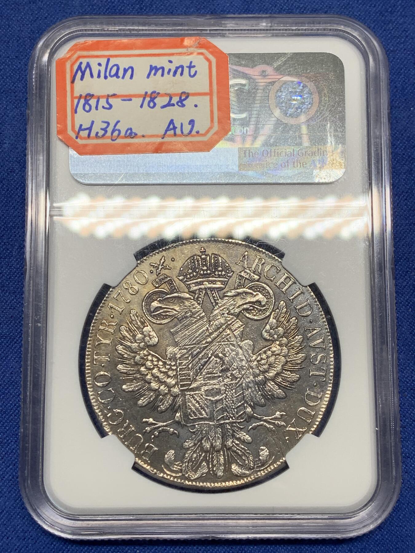 《竞宝斋》第468场 周日，周一 2场连拍 （全场包邮）欢迎送拍 NGC AU 少见1815至1828年米兰版玛丽亚特蕾莎贸易银币经典“中心正圆九珍珠”披风针，目录编号：哈夫纳36a。该版本为女皇逝世后，为了迎合近中东贸易货币使用习惯，由奥属意大利米兰造币厂铸造的版本，主要流通于北非、中东地区，是历史上真正参与流通的行用币！背面为减重痕。