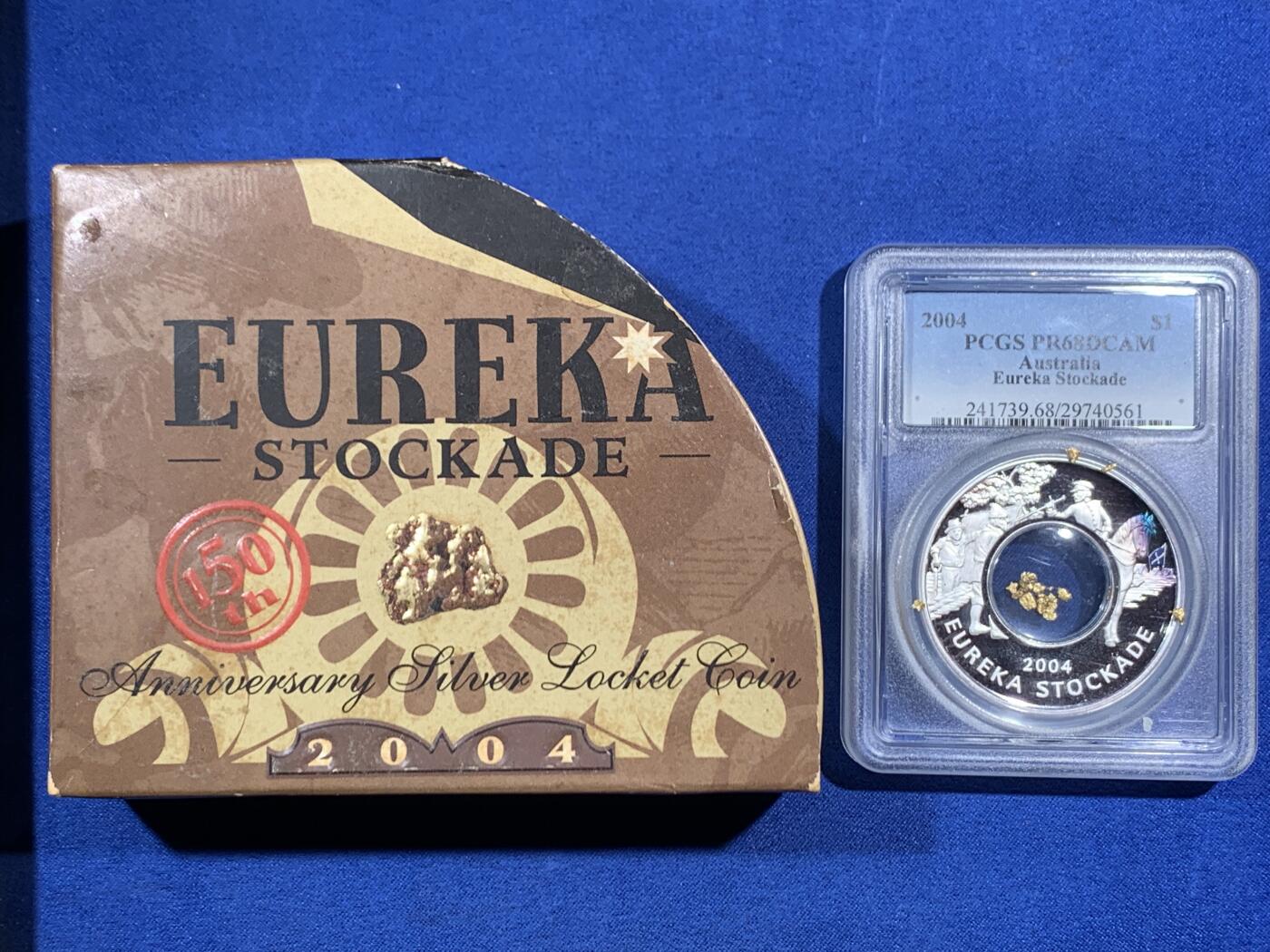 《竞宝斋》第469场 周日，周一 2场连拍 （全场包邮）欢迎送拍 PCGS PR68DCAM 澳大利亚2004年尤里卡堡垒150周年纪念精制银币 带金沙 999银 28.349克 铸造量11138枚 由珀斯造币厂发行 加厚盒 带木盒 细节见图