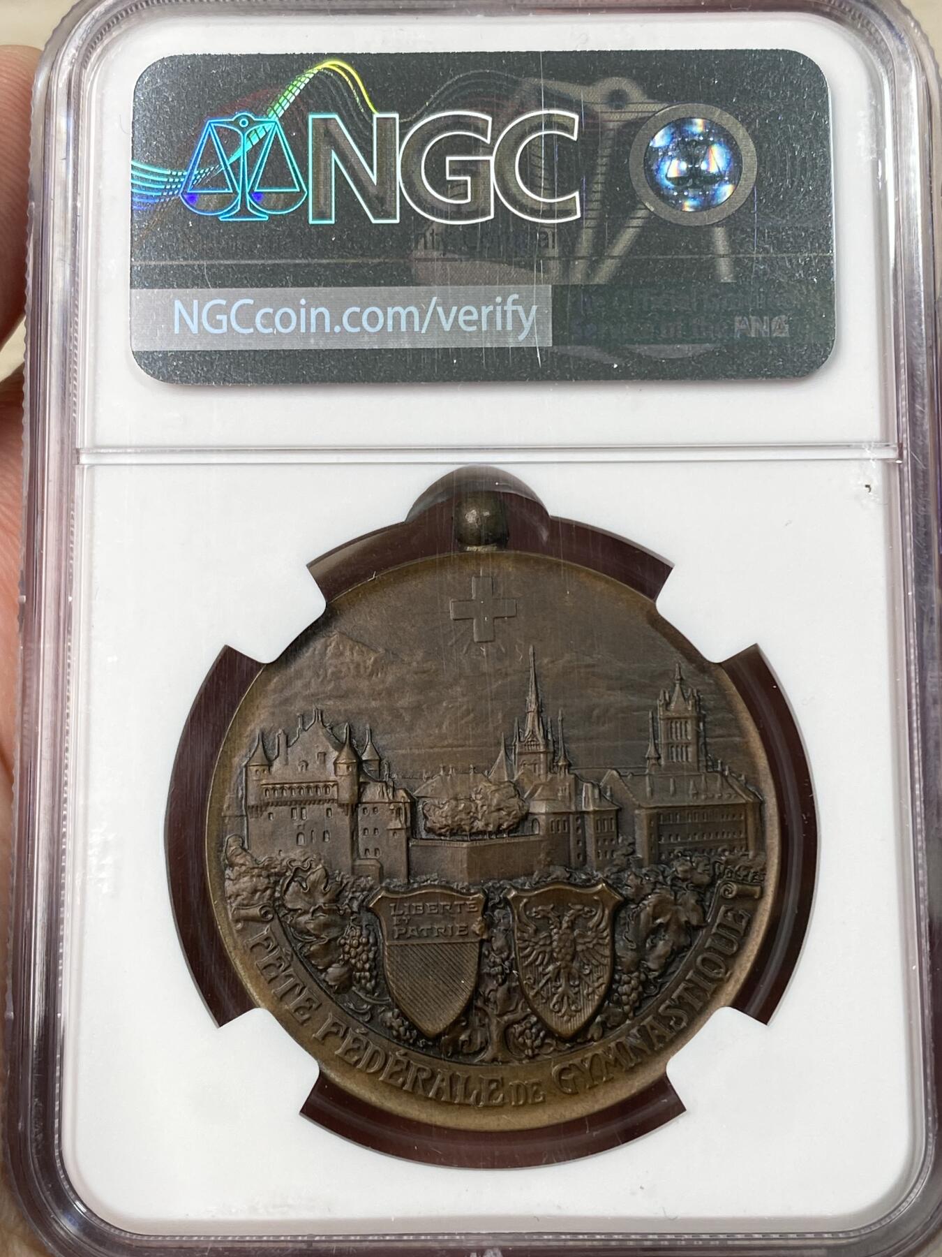 万国钱币拍卖第062期 NGC MS64 1909年瑞士洛桑体操联合会铜章 带吊环少见 背面是洛桑城市景观