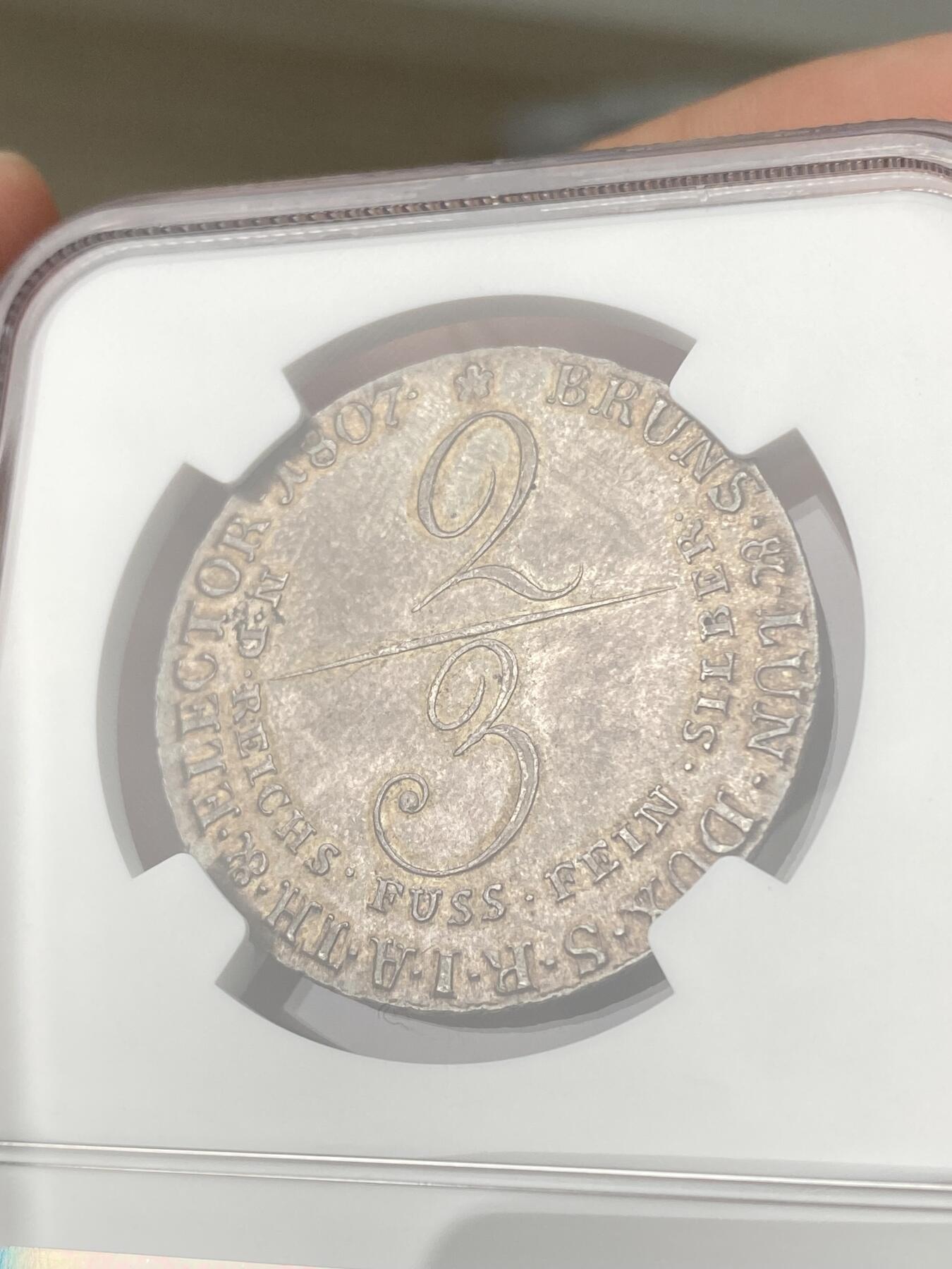 万国钱币拍卖第062期 NGC MS62 1807年德国汉诺威嘉德纹章2/3泰勒银币 罕见早期品种 全深打原味欧陆酱彩环绕 NGC唯二亚军分顶级收藏品质