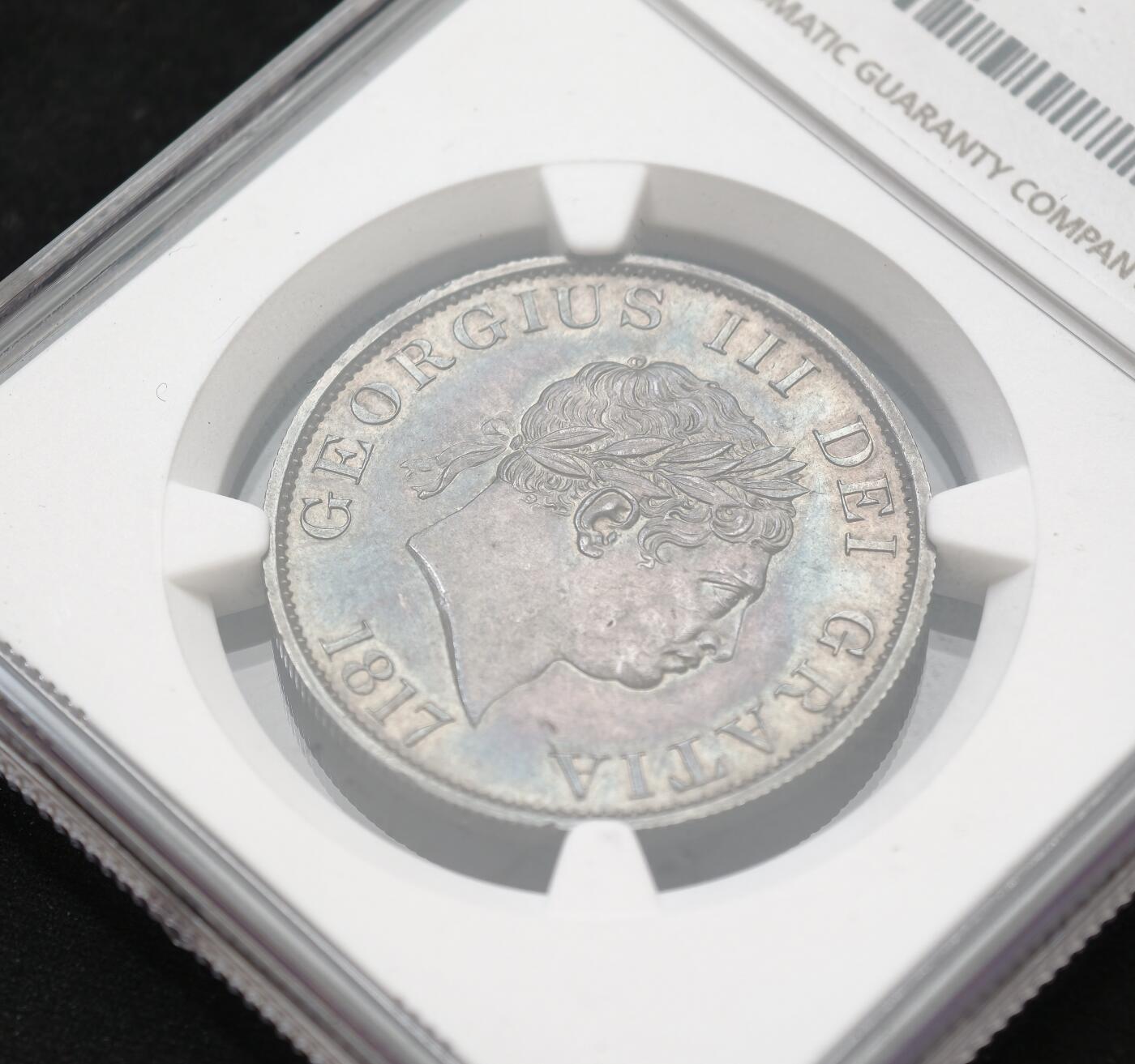 甄臻铺-世界币章拍卖（第54期），3月28日甄品场拍品征集中，送拍享返佣金等优惠多多 NGC-MS62 大英帝国1817年乔治三世牛头半克朗，黑五彩！实物上手令人惊艳的包浆。