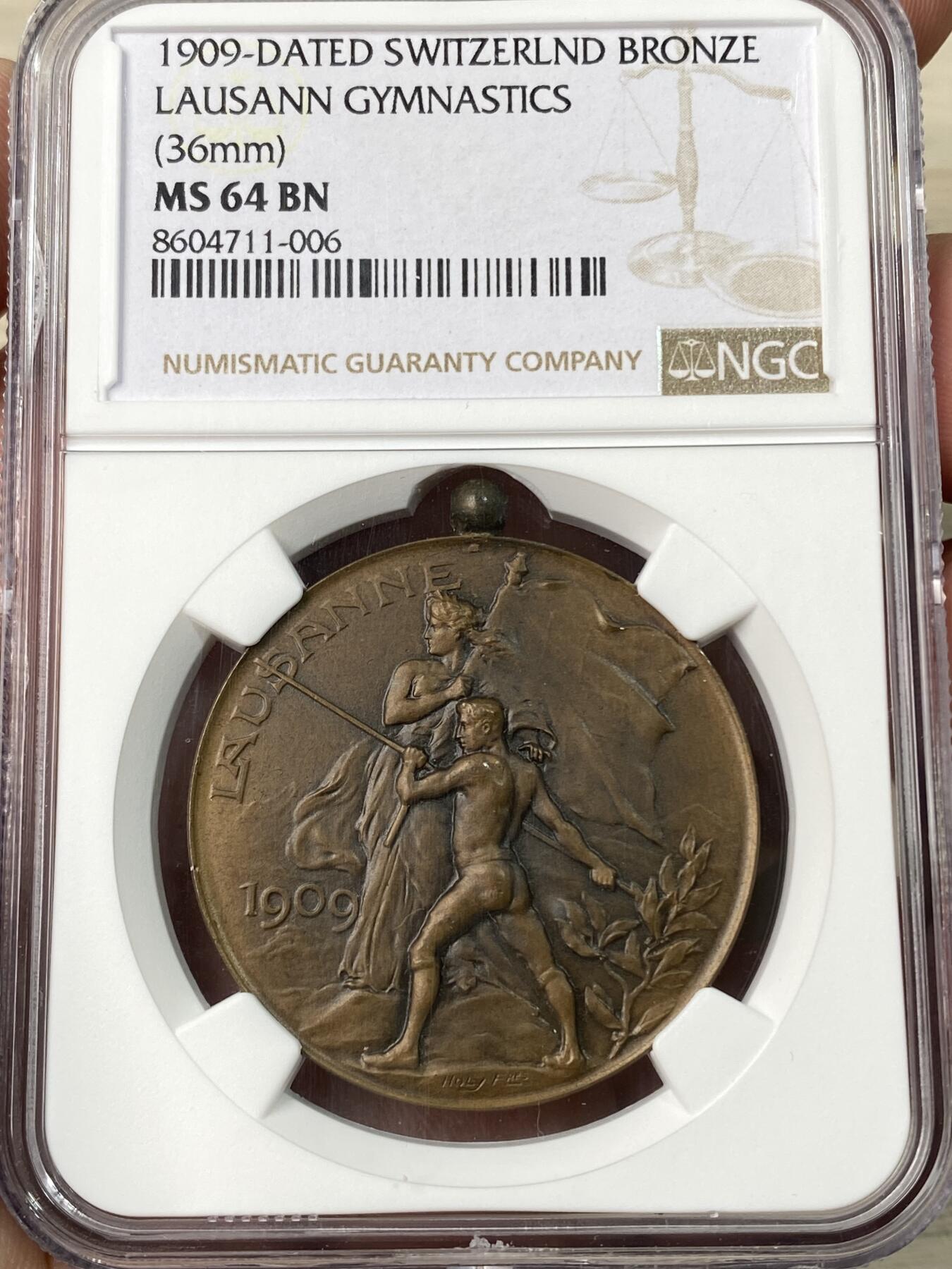 万国钱币拍卖第062期 NGC MS64 1909年瑞士洛桑体操联合会铜章 带吊环少见 背面是洛桑城市景观