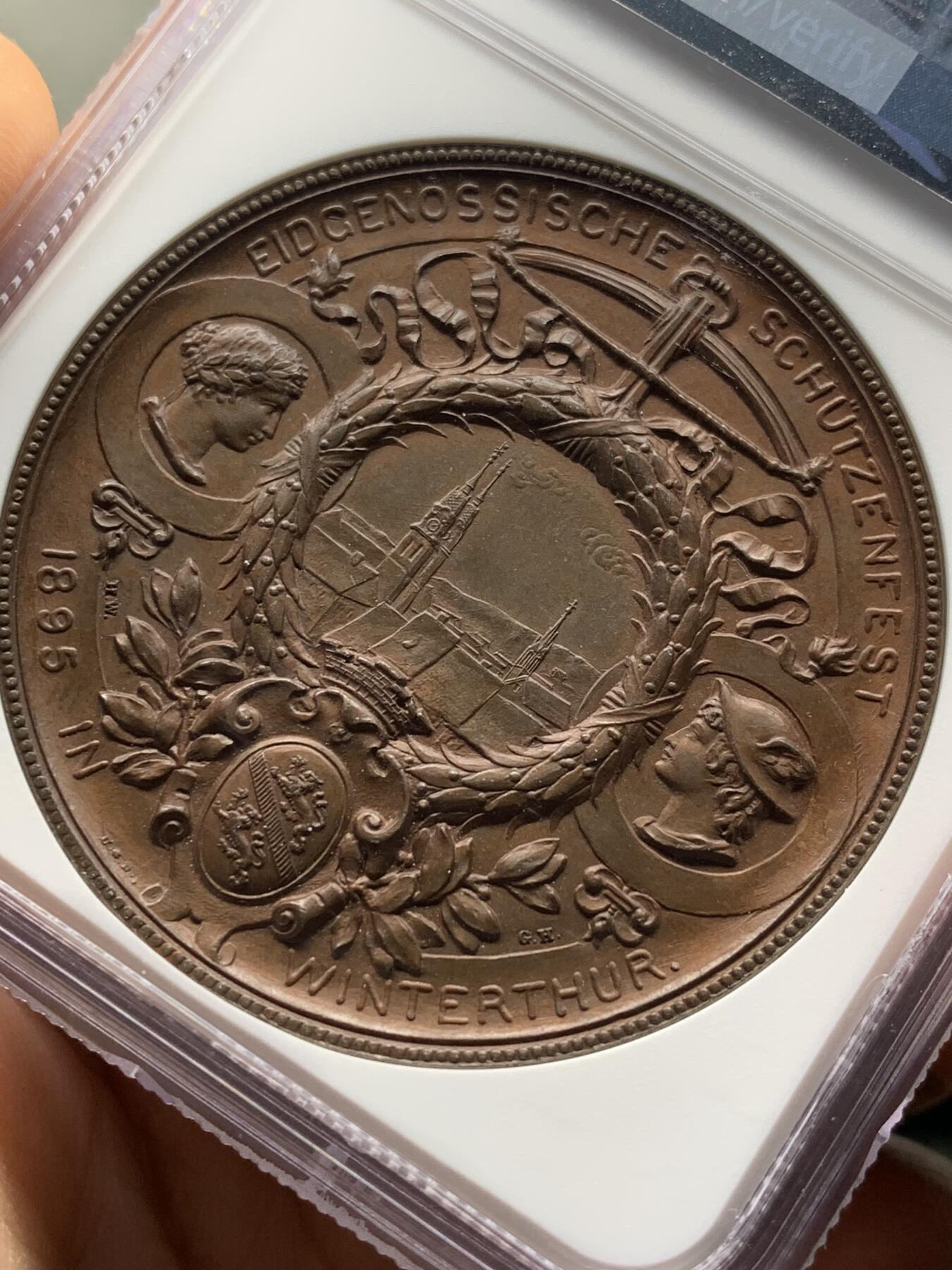 《竞宝斋》第471场 周日，周一，周二 3场连拍 （全场包邮）欢迎送拍 NGC MS64BN 瑞士1895年景观大铜章，正面女神捧花，背面市景和双人物头像，高浮雕设计，丝滑巧克力。