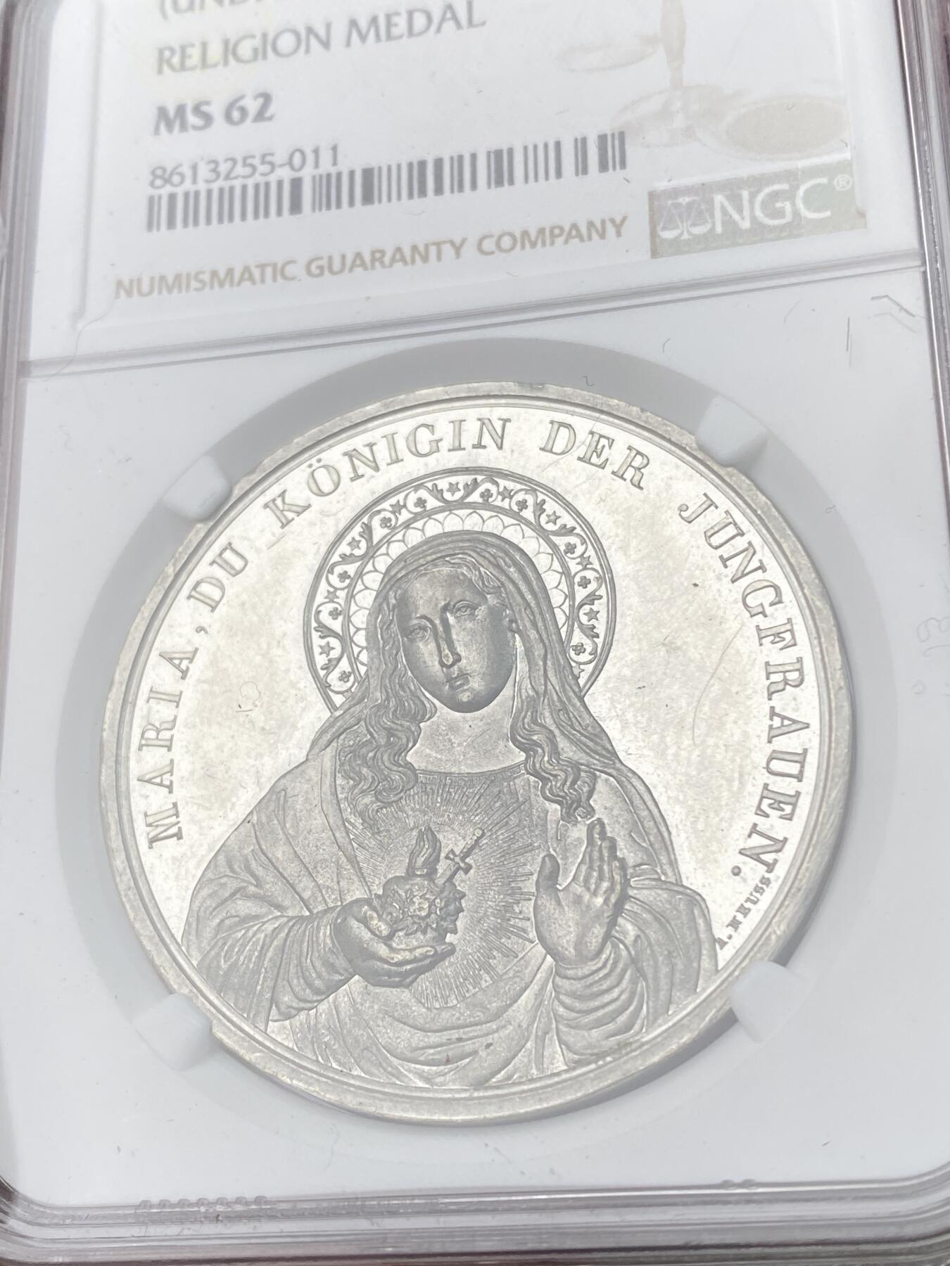 万国钱币拍卖第063期 NGC MS62 19世纪德国坚信礼圣母玛利亚纪念锡章 深度镜面精铸浮雕喷砂质感 锡制章牌出分极其不易 圣母形象刻画极其生动 背面天主十字架插在地球之上 下面是各类宝物代表财富