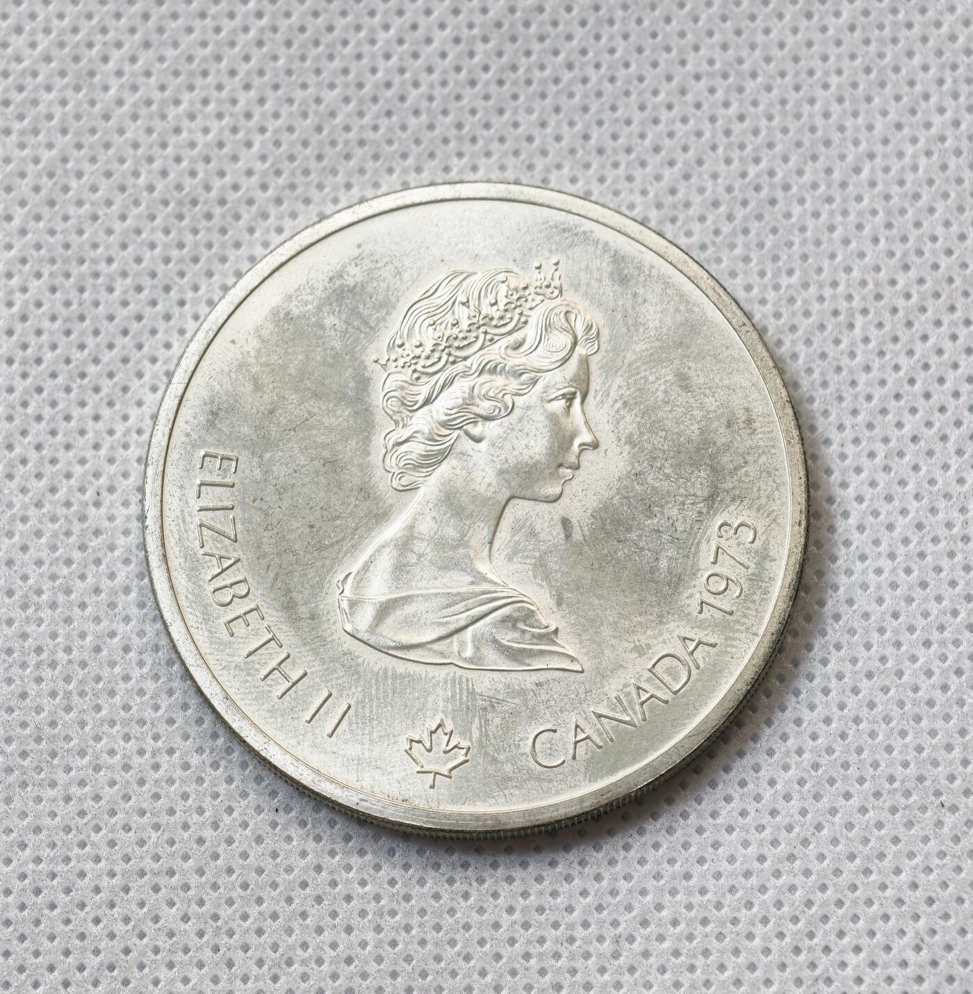 甄臻铺-世界币章拍卖（第55期），3月28日甄品场（直播拍卖）拍品征集中，送拍享返佣金等优惠多多 1973年加拿大奥运会10元大银币（2），48.6克925银