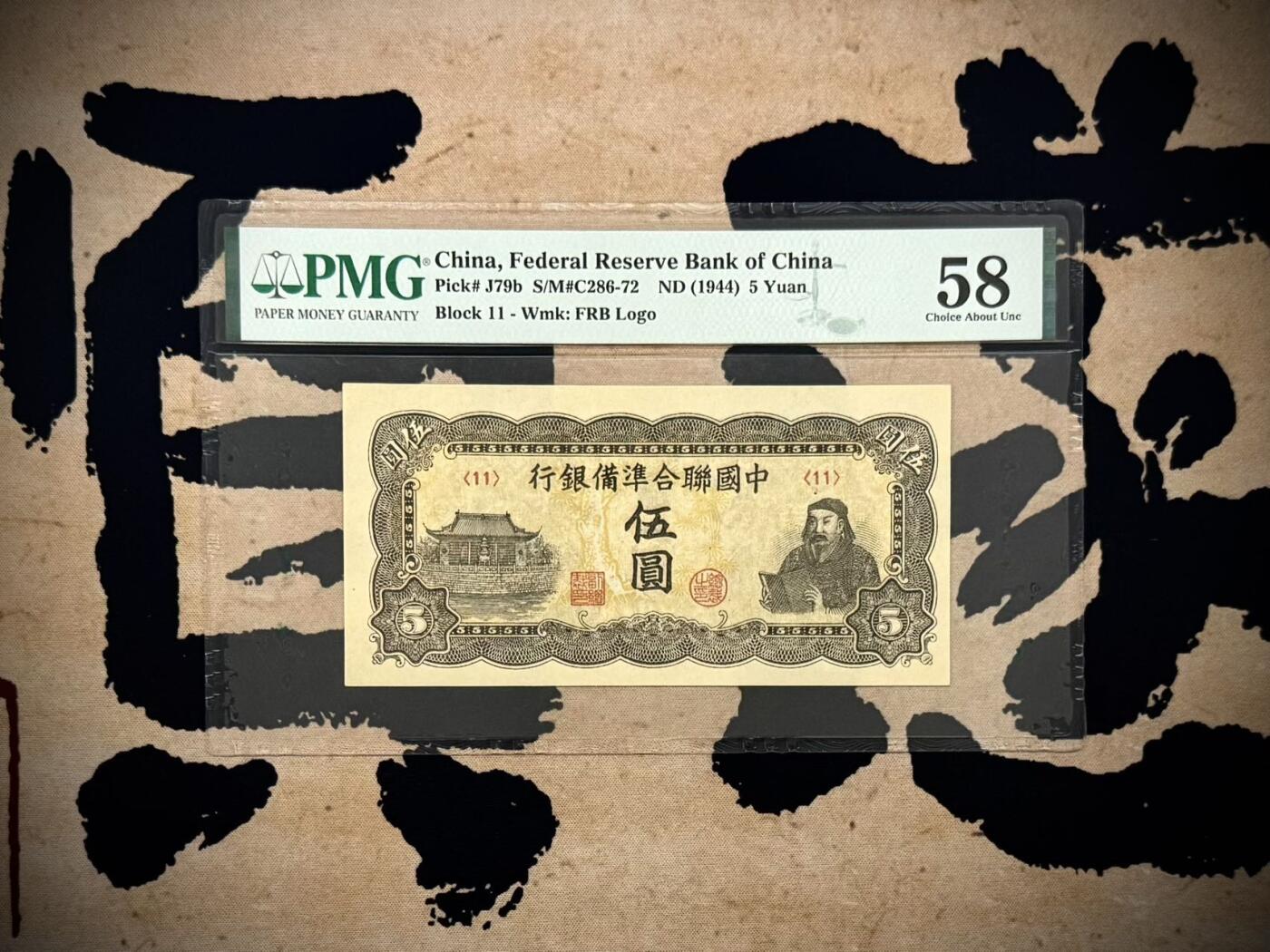 （自动截拍）PMG评级民国纸币专拍第20260321期，全场包邮 【乾奕收藏】出民国33年1944年中国联合准备银行伍圆，水印版，行标水印，右岳飞蟒袍捧书图案，美国PMG58分，油墨浓郁，图案清晰，同分数中状态较为出色的一枚