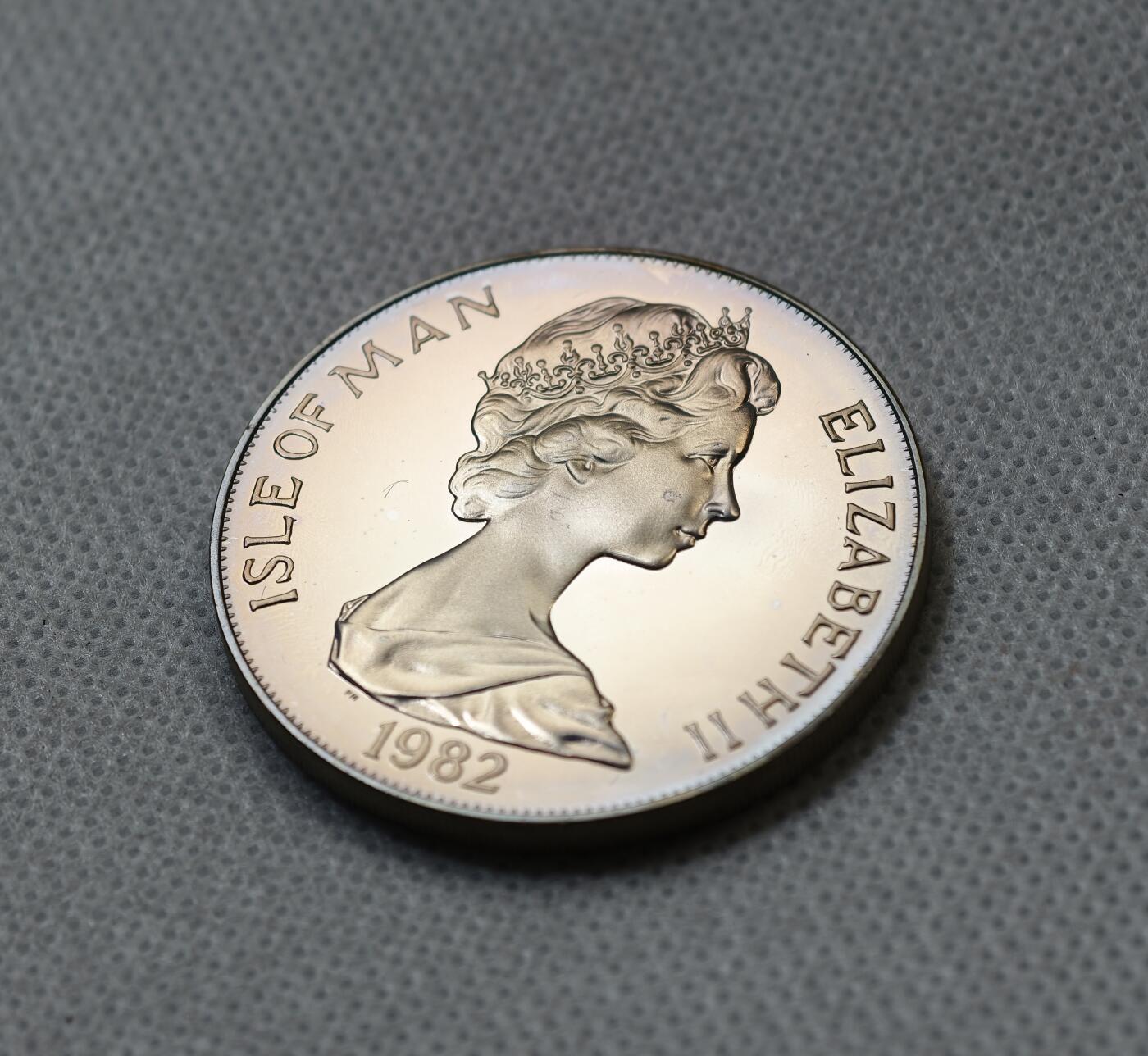 甄臻铺-世界币章拍卖（第55期），3月28日甄品场（直播拍卖）拍品征集中，送拍享返佣金等优惠多多 1982年马恩岛1克朗精制银币，FIFA世界杯主题，预热品种，发行量1.5万枚，28.5克925银