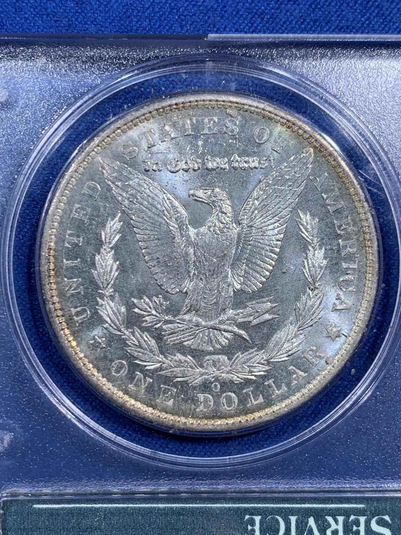 《竞宝斋》第473场 周日，周一 2场连拍 （全场包邮）欢迎送拍 PCGS MS64PL 美国1904-O 摩根1美元大银币，绝版初代P盒，盒子历史就已近40年。 PL大多是白币，彩币出PL极难，此枚绚丽五彩+PL镜面+绝版盒，真正藏家品质，摇摇乐不可多得的品种