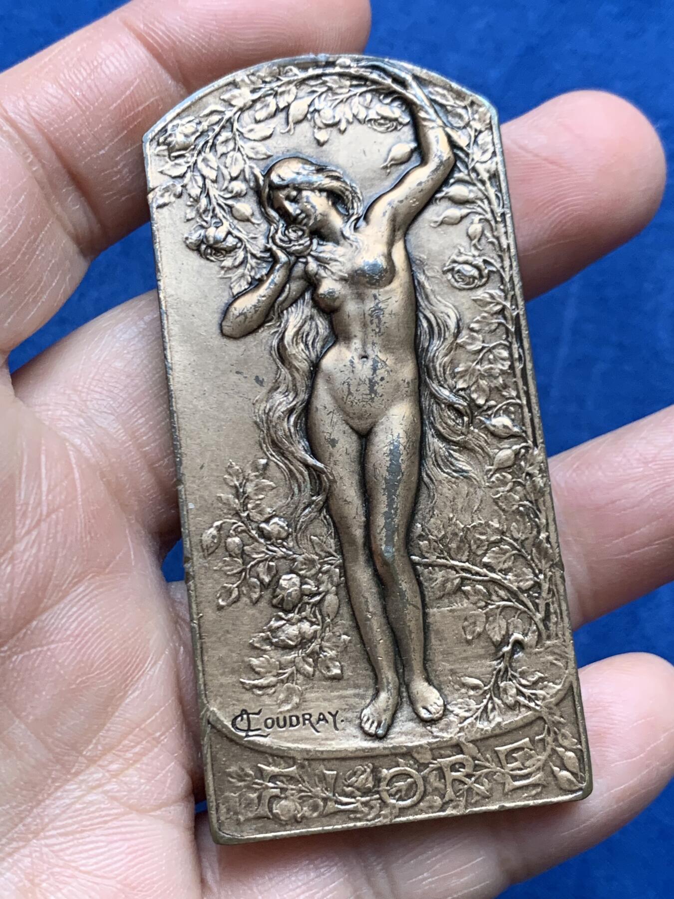 《竞宝斋》第474场 周日，周一 2场连拍 （全场包邮）欢迎送拍 法国新艺术时期异形大铜章，花神芙罗拉。81.7克，35.2*74mm，COUDRAY大师名誉作，非常稀见的品种，花神立于鲜花锦簇中，身姿舒展曼妙，刻画精美细腻，生动美好。表面有油漆保护层，细节见图。