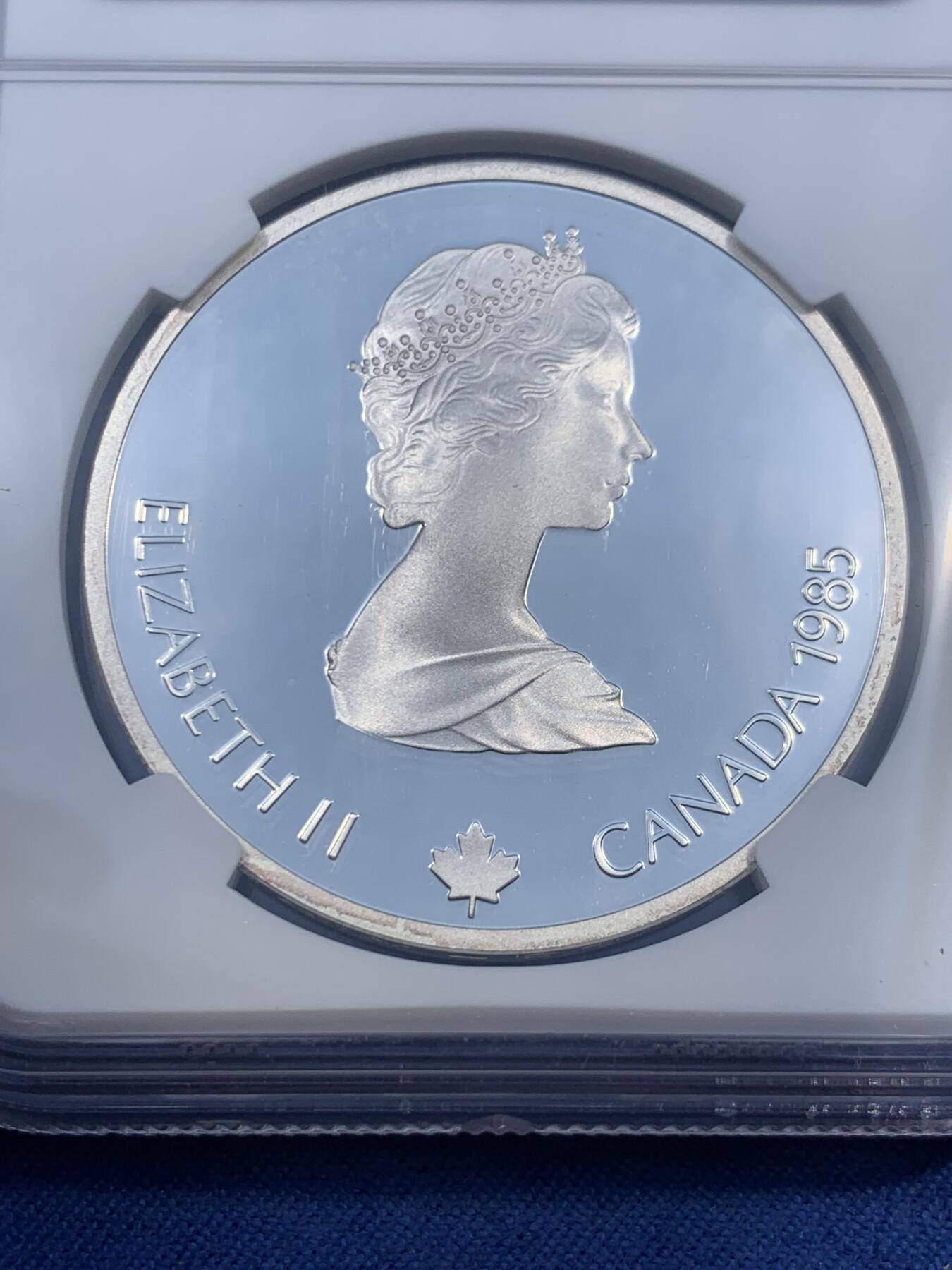 《竞宝斋》第474场 周日，周一 2场连拍 （全场包邮）欢迎送拍 NGC PF69UC 加拿大1985年卡尔加里冬奥会滑雪银币，克劳斯获奖币