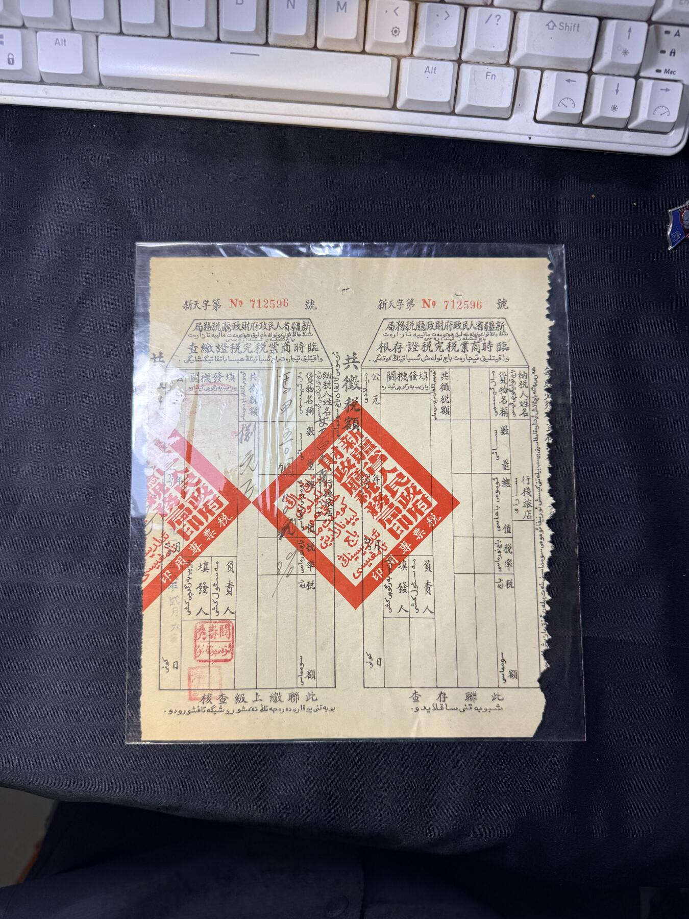云宸嘉赏-勋臻文献佳藏优品精选场次（低佣 转发佣金红包） 解放初期新疆省时期人民政府财政厅税务局 临商税票 新天字第 712596 号  加盖四方大印   汉维双语设计具有鲜明的时代与地域特征，是研究新疆近现代史、税收史与民族政策的重要档案