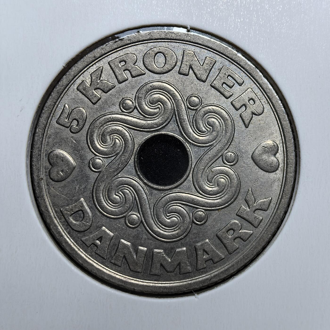 外国优质老铜币银币苏联纪念章，每周六晚九点倒数截拍，满百包邮可寄存，持续收拍 丹麦1990年5克朗镍币，独特中孔设计，正面维京漩涡纹饰，背面玛格丽特二世王冠纹章与爱心符号，北欧风情浓郁，是丹麦现代钱币收藏的特色佳品。