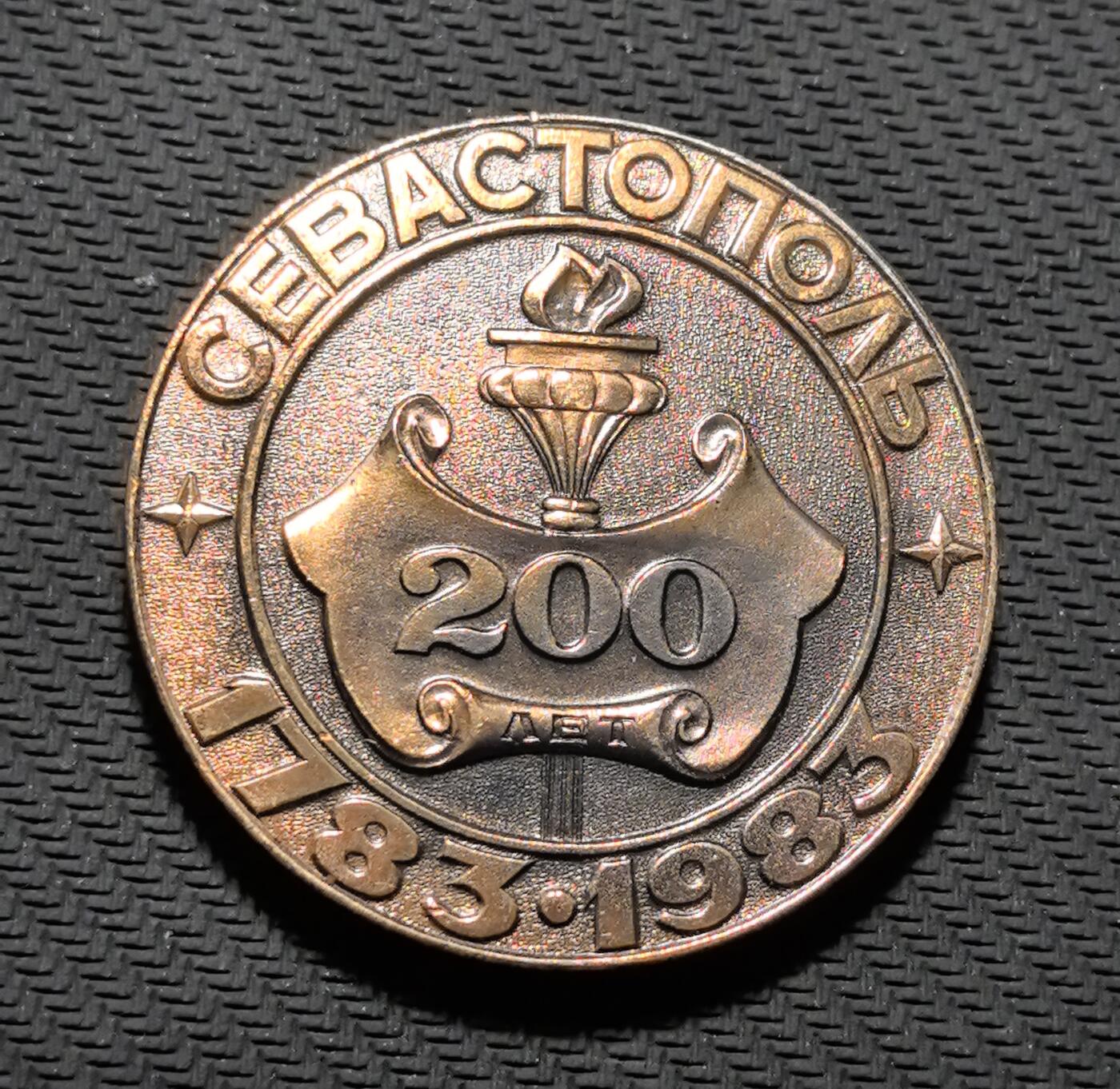 外国优质老铜币银币苏联纪念章，每周六晚九点倒数截拍，满百包邮可寄存，持续收拍 塞瓦斯托波尔建城 200 周年纪念章直径50mm重25克，正面复刻 18 世纪风帆战舰与城市地标，传递黑海港口的航海底蕴；背面以 “200 ЛЕТ” 与永恒火炬铭文，见证这座英雄城市的百年沧桑。铜质包浆温润厚重，航海浮雕细节饱满，是兼具黑海史与城市记忆收藏价值的珍贵纪念章。