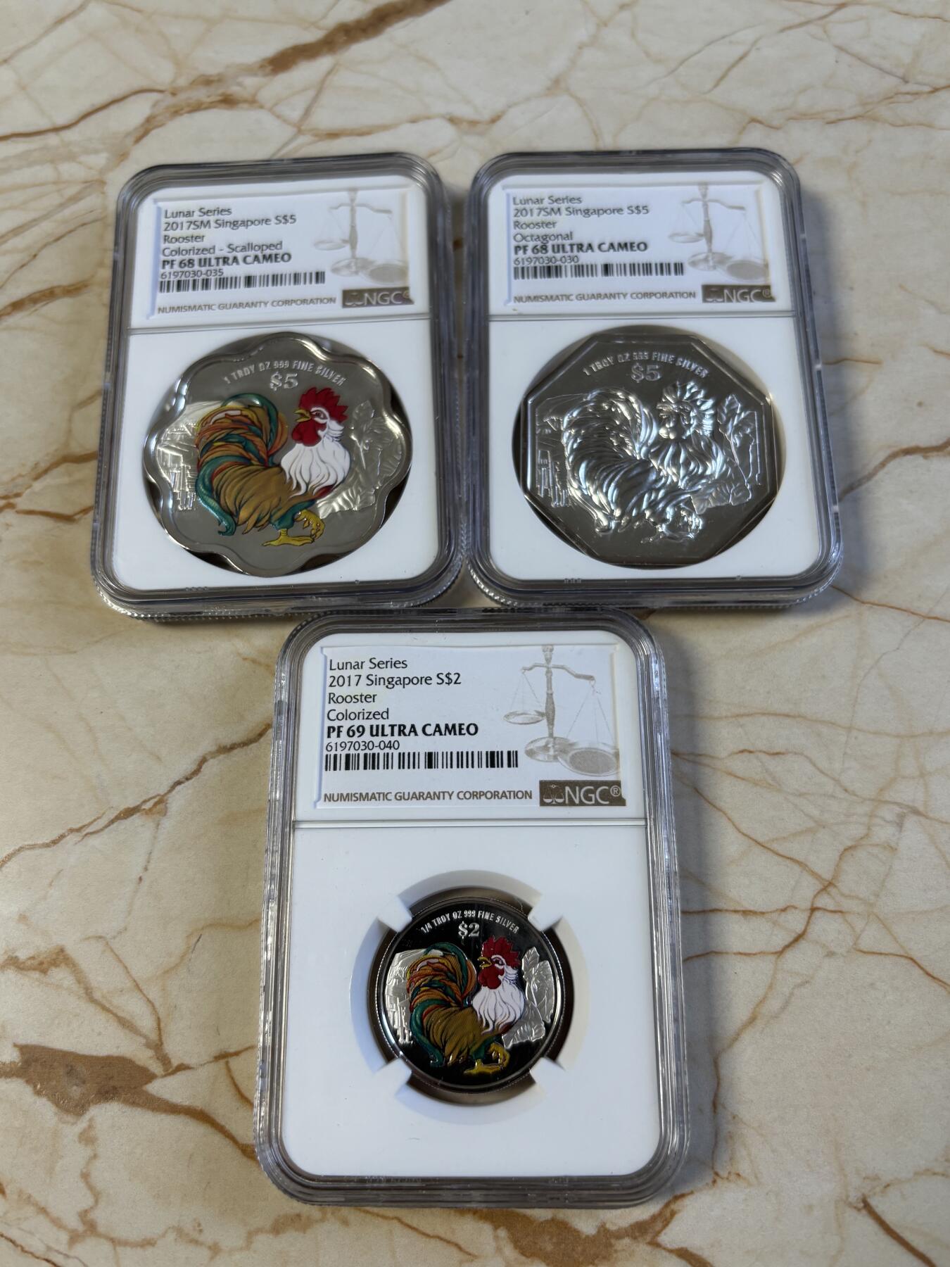 第194期拍卖 新加坡2017年十二生肖鸡年银币3枚套NGC-PF68一枚，PF69-2枚，1盎司/1盎司/1/4盎司，999银，发行2000套