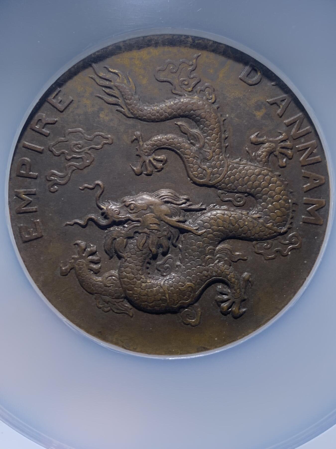 《竞宝斋》第475场 周日，周一 2场连拍 （全场包邮）欢迎送拍 NGC MS61BN 安南帝国1931年保大时代大龙铜章 巧克力包浆 厚大尺寸 正面安南皇帝身着朝服手持象牙笏板正面而立于双龙之间 背面一条神龙盘踞云中 铭刻“安南帝国” 该系列中的龙头名誉品种 外拍高价品种 加厚盒