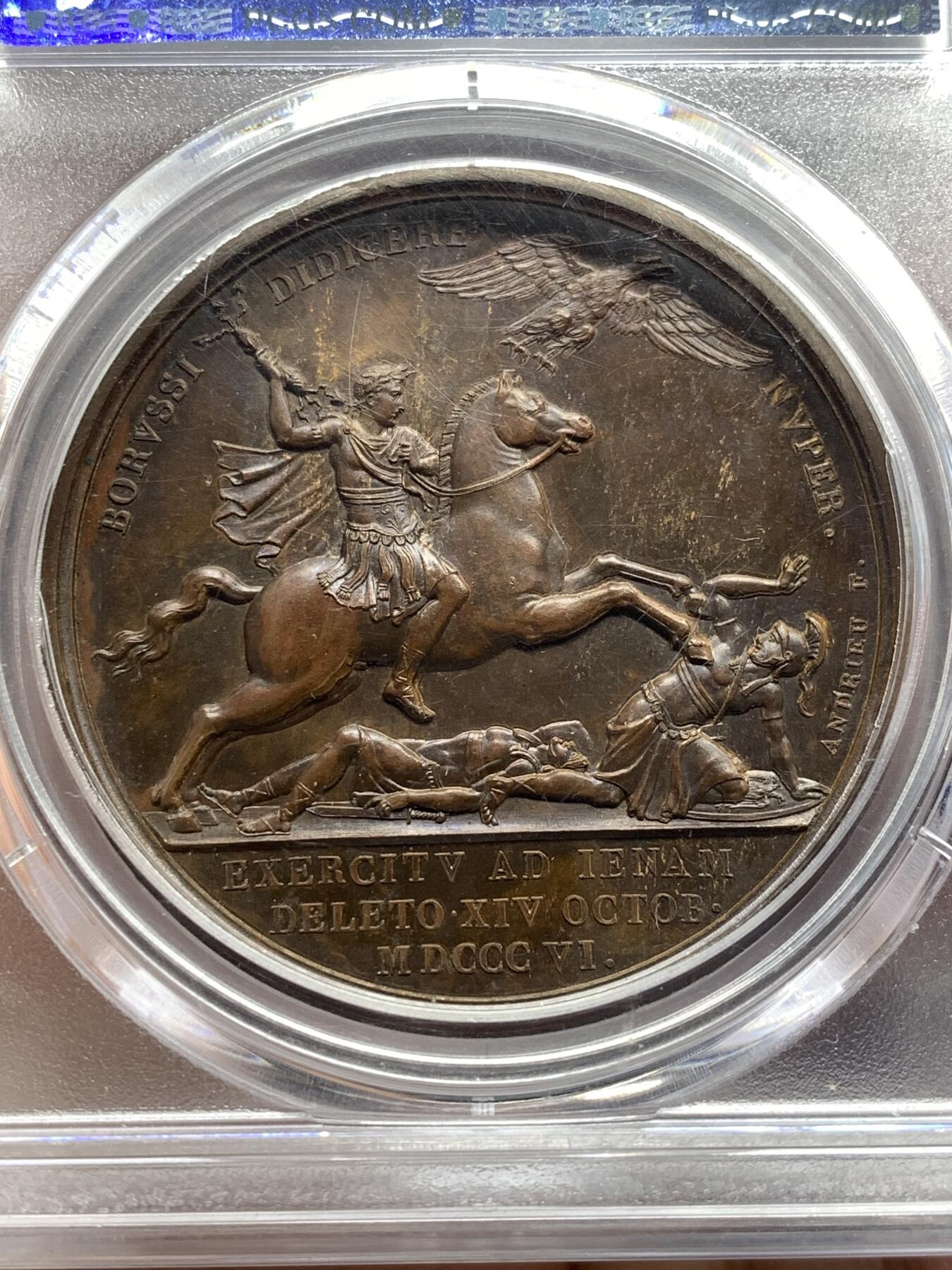 《竞宝斋》第476场 周日，周一 2场连拍 （全场包邮）欢迎送拍 PCGS SP64  法国1806年拿破仑一世耶拿之战原铸铜章 巴黎造币厂巧克力包浆 拿破仑化身朱庇特(罗马神话中众神之王)身披斗篷骑着帝国之鹰腾云凌空 手持闪电权杖 击倒斩杀地上三名巨人 场面英武壮阔设计大胆天马行空 肌肉线条精细优美该战役是拿破仑大破普军经典战役 也是拿章中经典中的经典 加厚盒