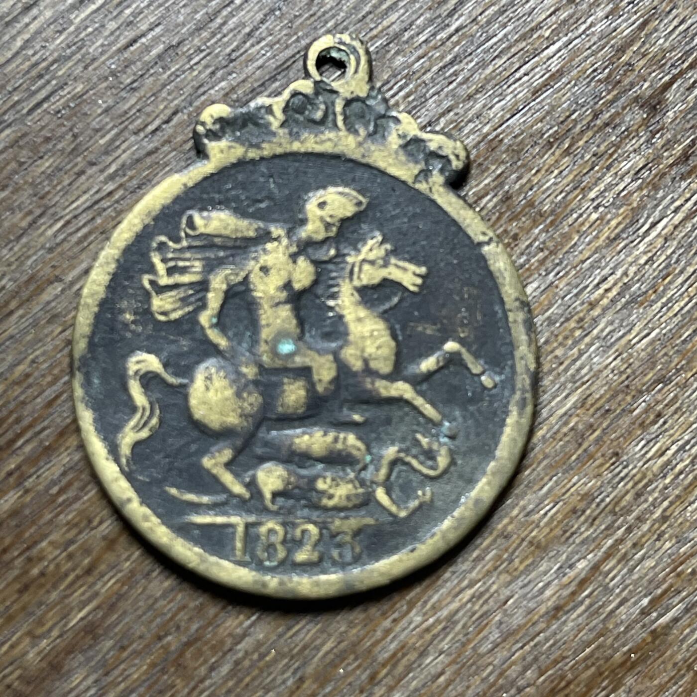 1823年英国乔治四世时期“马剑”纪念章/代币吊坠，并非流通货币，材质为黄铜/青铜，是典型的欧洲古董饰品。