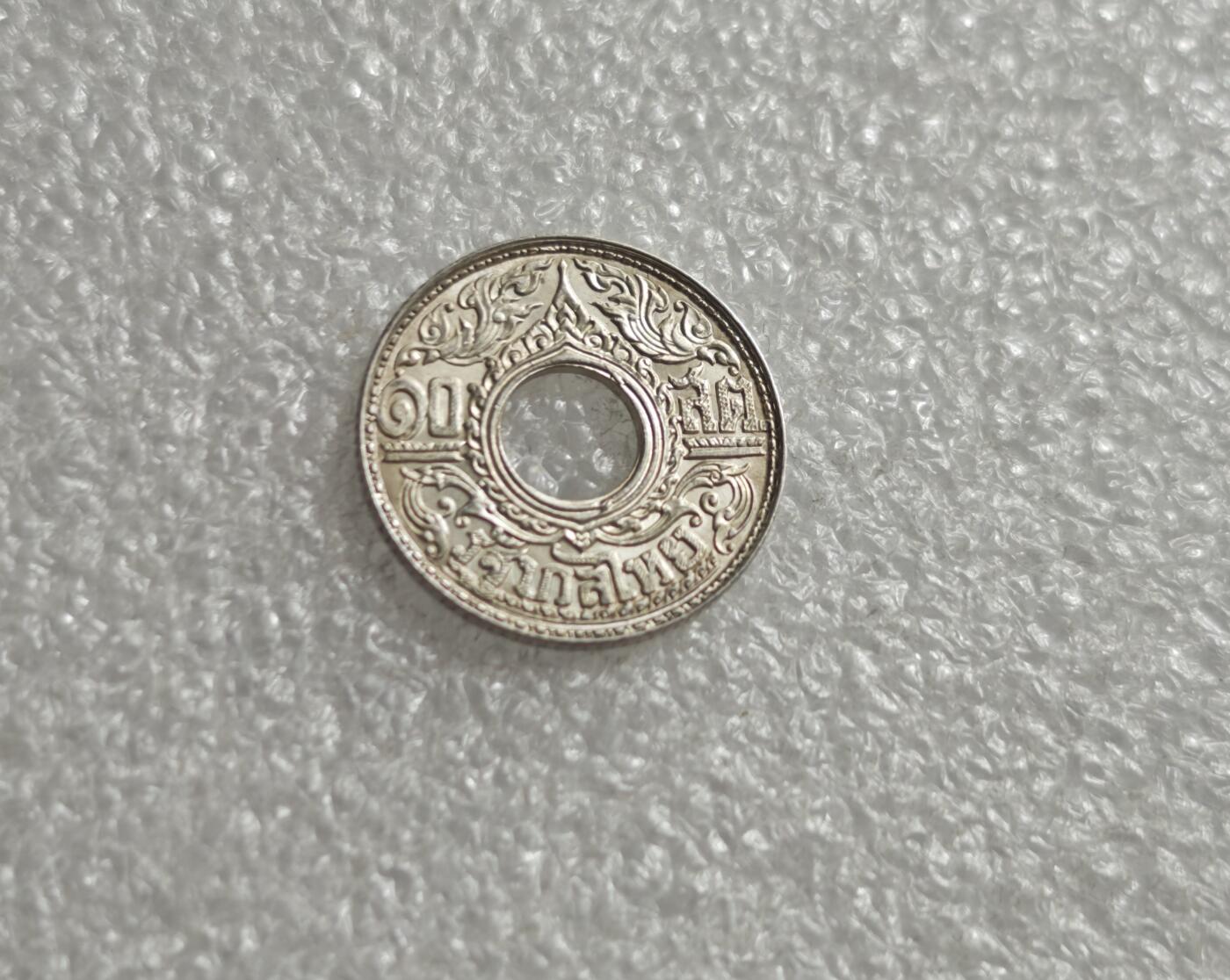 瓶子🏺第235期拍卖会  泰国（暹罗）1940年的10萨当（1/4铢）圆孔银币，是泰国近代货币史上的经典品种，融合了泰式艺术与西方造币工艺