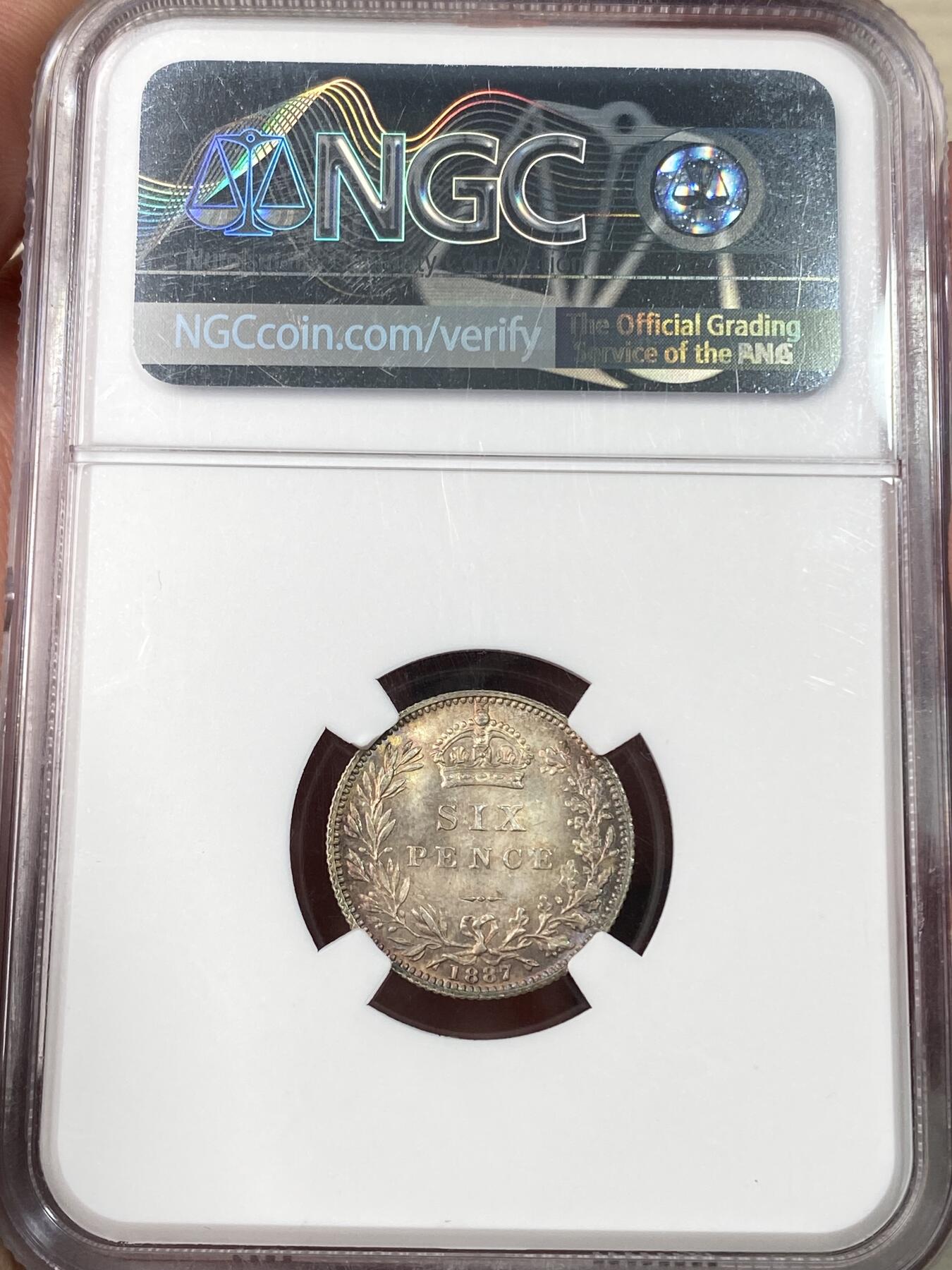 万国钱币拍卖第064期 NGC MS65 1887英国维多利亚女皇高冠6便士银币面值版 华丽英式天鹅绒五彩也难掩其底光迸发 小中见大的顶级BU状态 典藏级品质