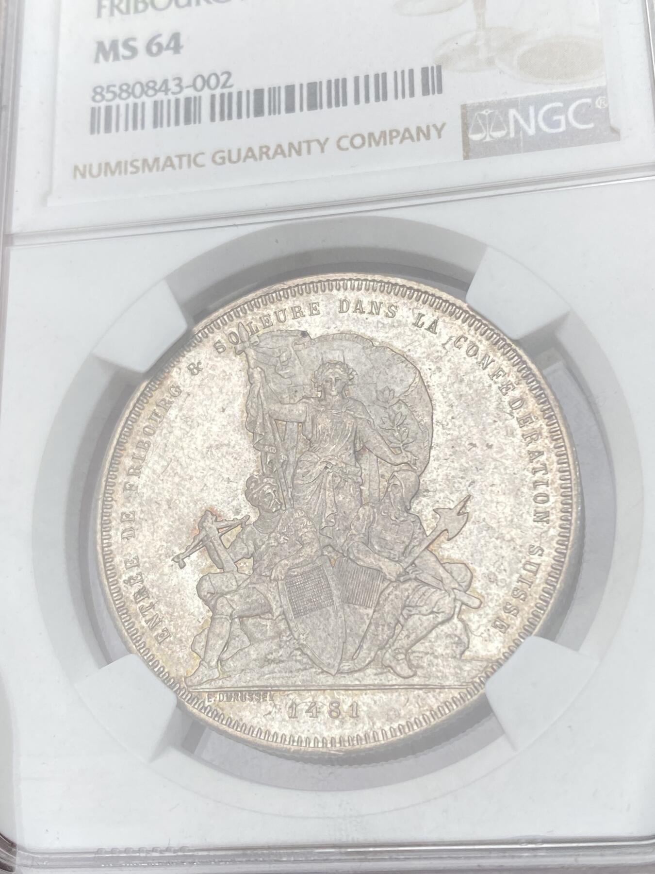 万国钱币拍卖第064期 NGC MS64 1881年瑞士弗里堡射击节经典城市景观5法郎 广受欢迎的瑞射景观系列 银霜转光香槟金淡彩环绕 极其舒适的收藏级品质