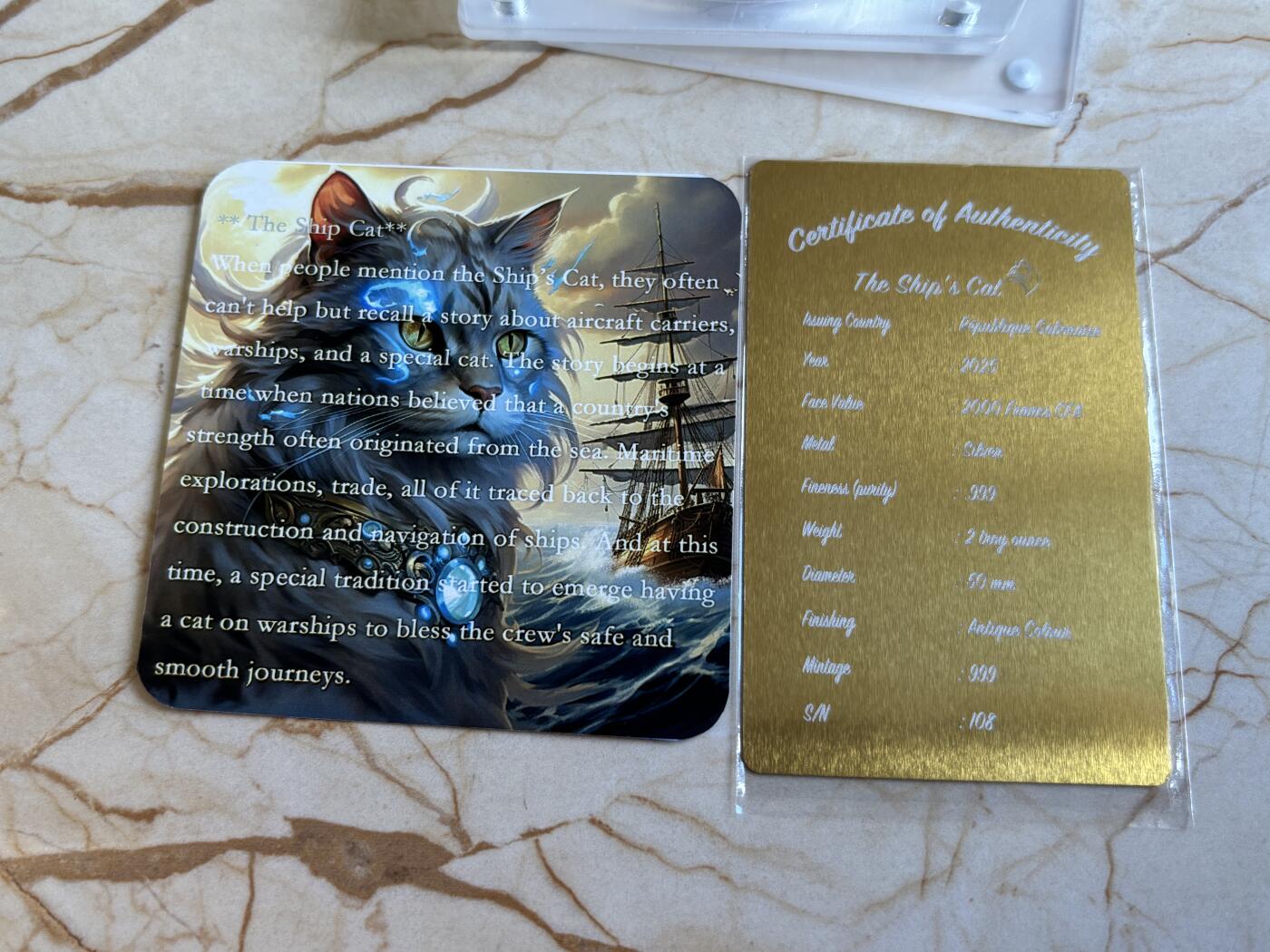 第195期拍卖 加蓬2025年海上舰猫2盎司仿古彩色夜光高浮雕银币，999银，编号108，总发行量999枚，原盒证书，发售价1788元