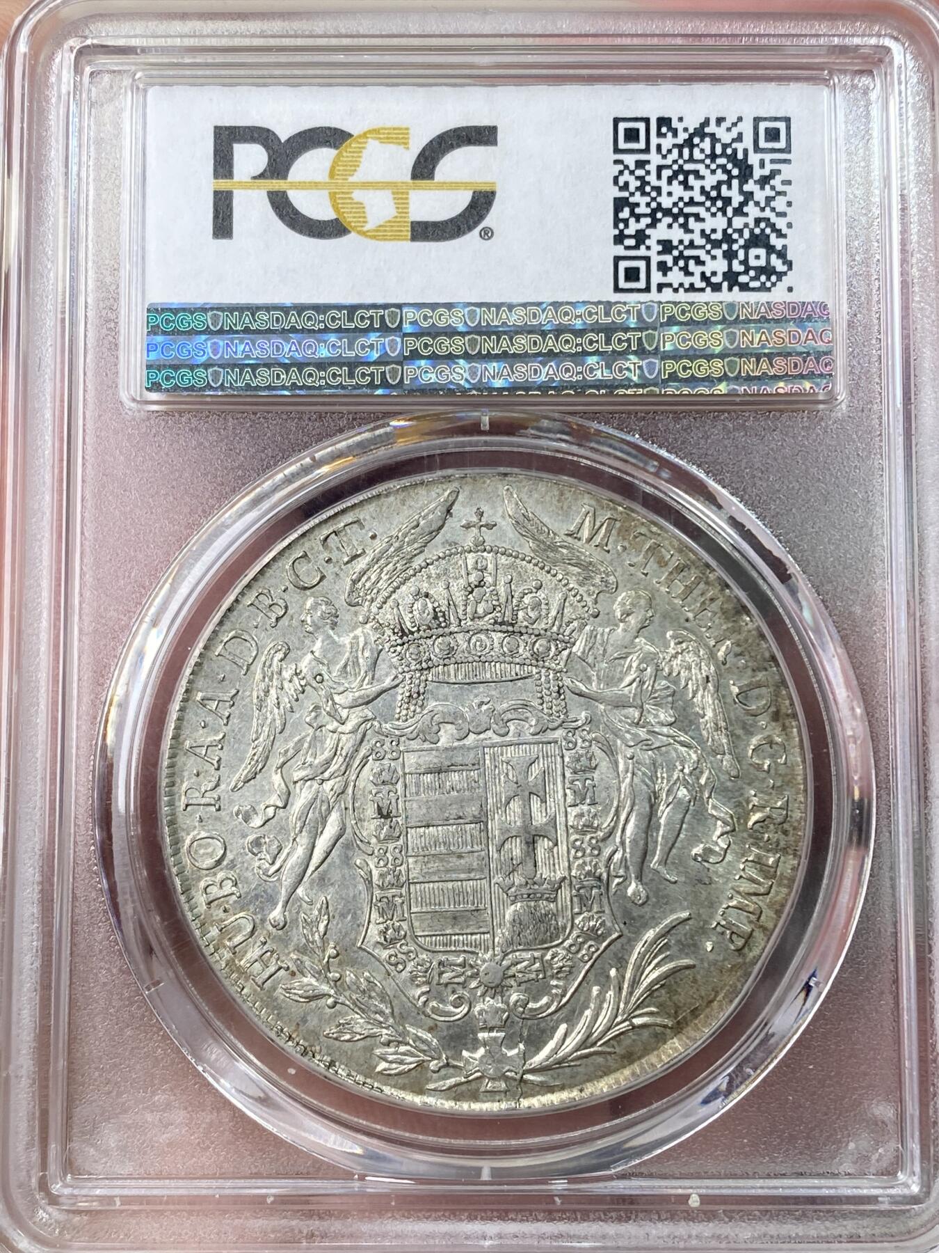 万国钱币拍卖第064期 PCGS MS63 1780年匈牙利神圣罗马帝国皇帝约瑟夫二世圣母抱婴泰勒 克雷姆琴察造币厂铸 高品罕见的神罗匈牙利洗礼 PC亚军分更高仅一枚 圣光环绕着圣母与圣子 背面两位大天使献上祝福 超级深铸银光充沛无减重痕罕见典藏级