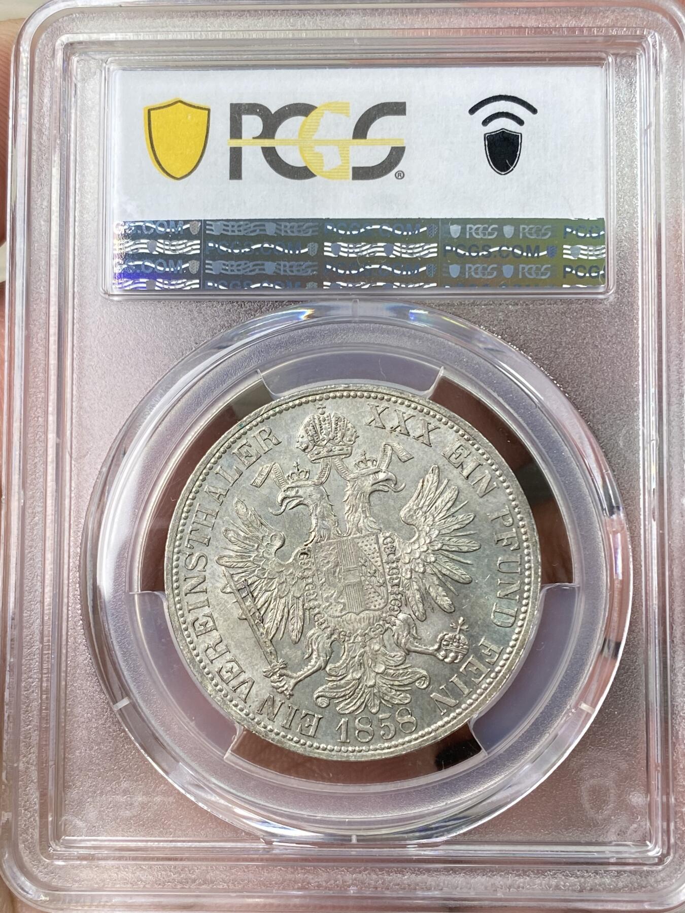 万国钱币拍卖第064期 PCGS MS63 1858年奥地利弗朗茨一世双头鹰流通1泰勒 维也纳货币协议的产物 与德国联合泰勒形制相同 车轮转光欧陆原味淡彩环绕极美收藏品质
